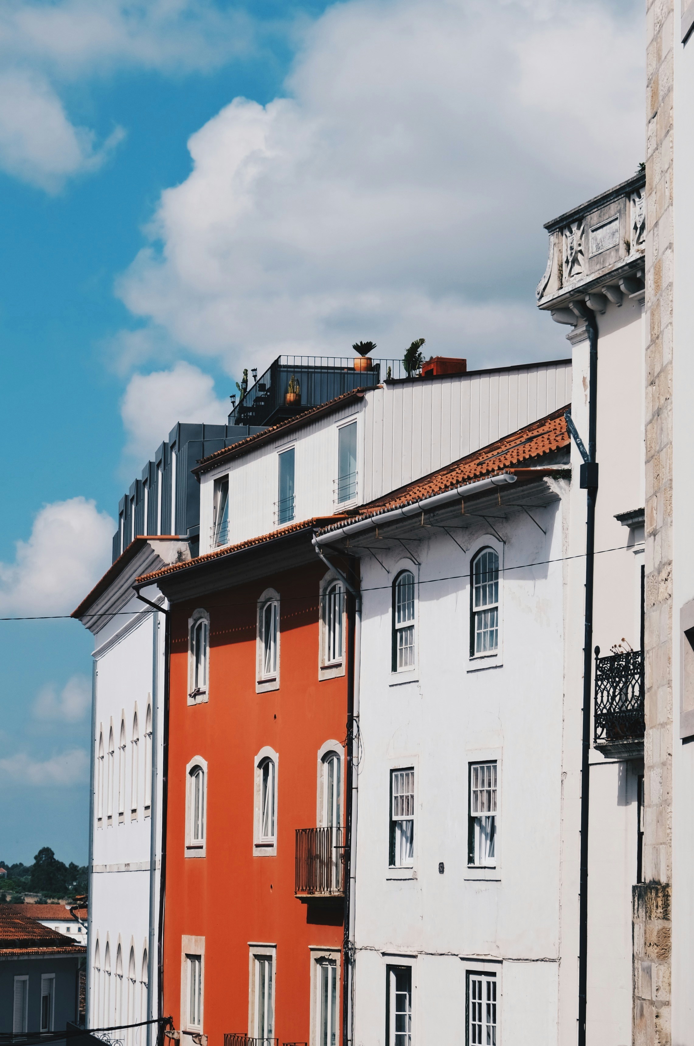 Buildings with colorful facades stand under a blue sky.