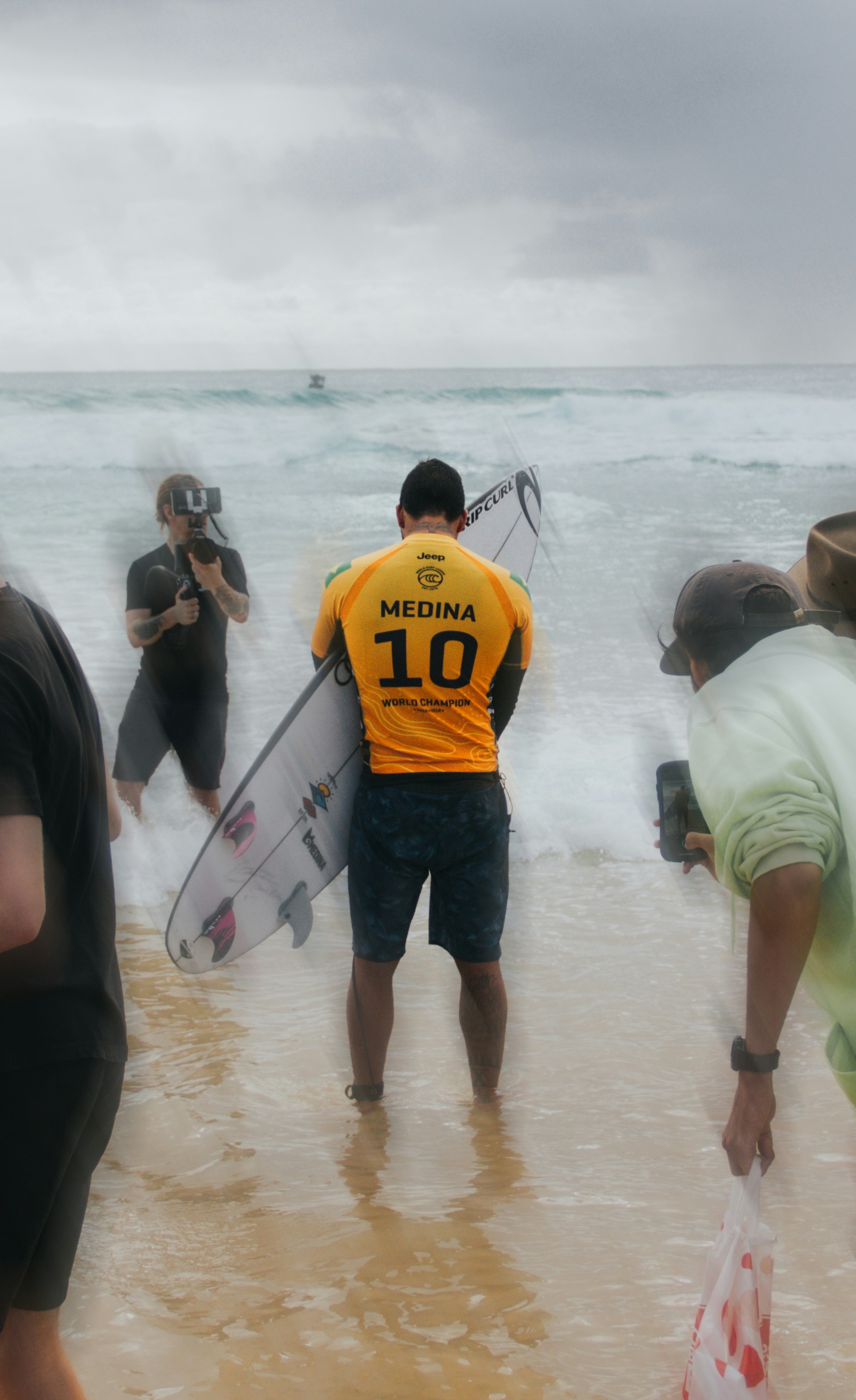 A surfer named medina prepares to enter the ocean.