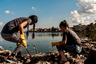 Volunteers cleaning up trash by the water.
