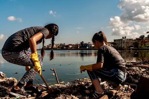 Volunteers cleaning up trash by the water.