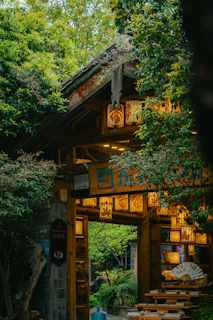 An illuminated archway leads to a garden.