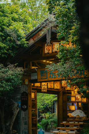 An illuminated archway leads to a garden.
