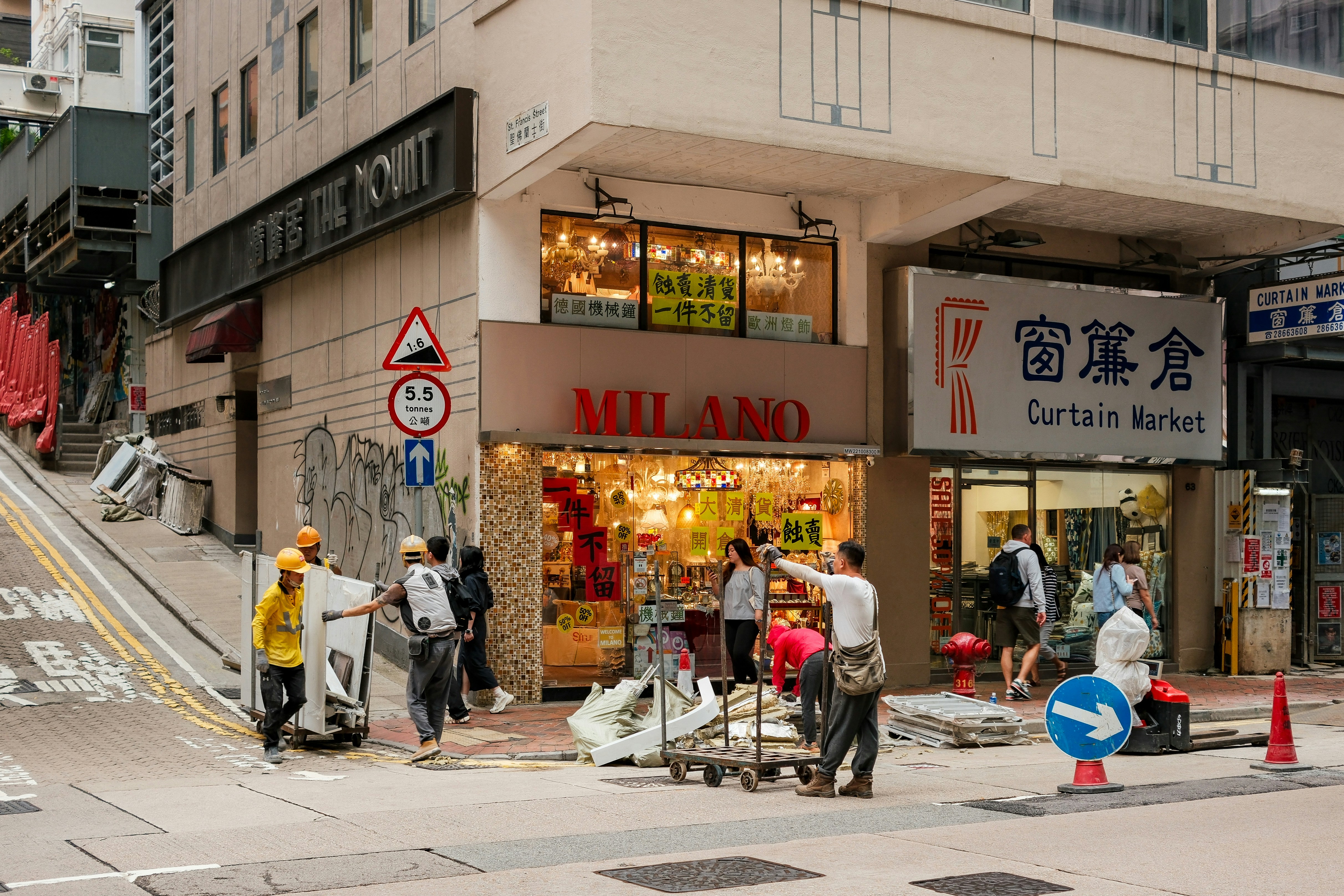 Shops are on a busy city corner.