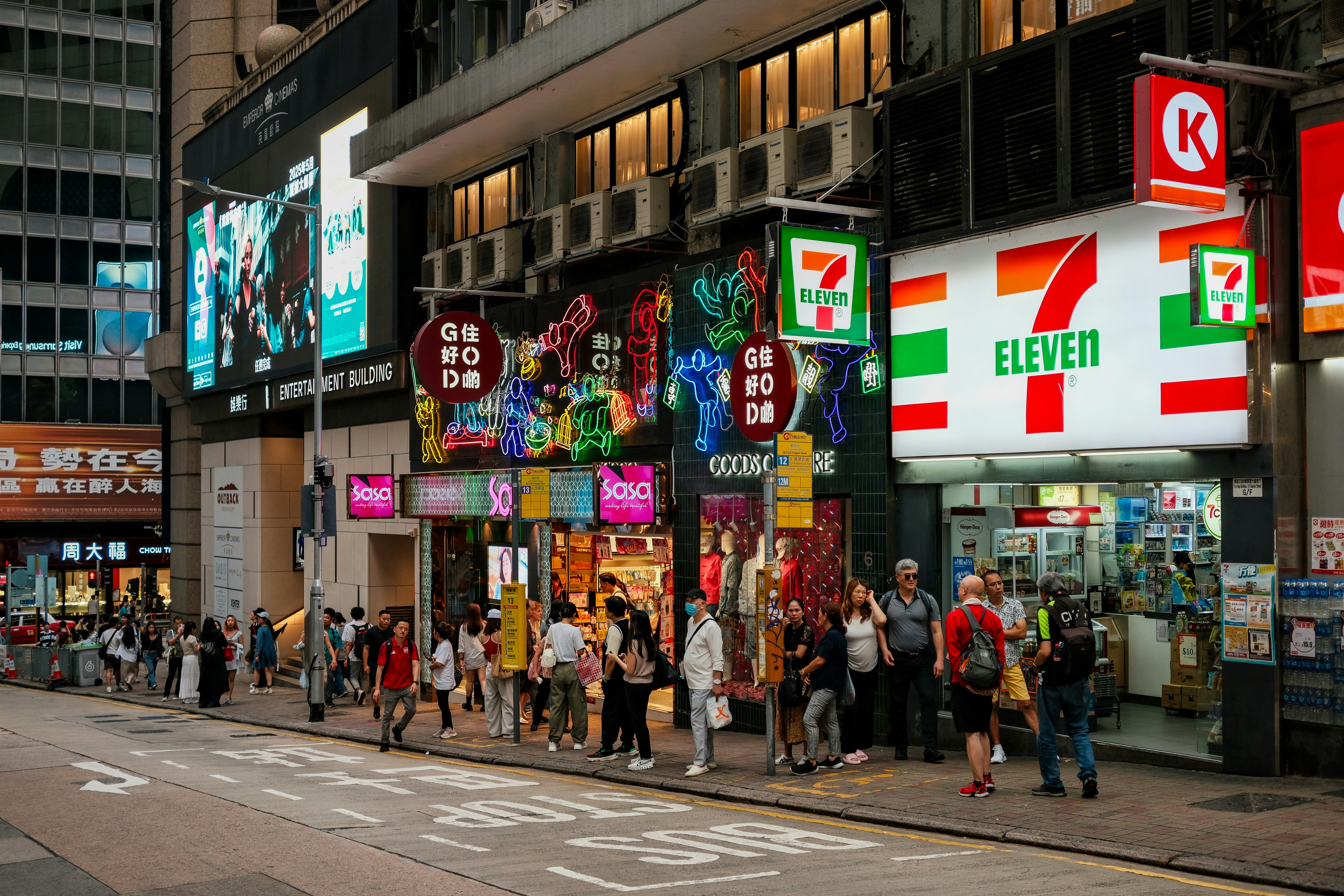 A busy street scene with people and shops.