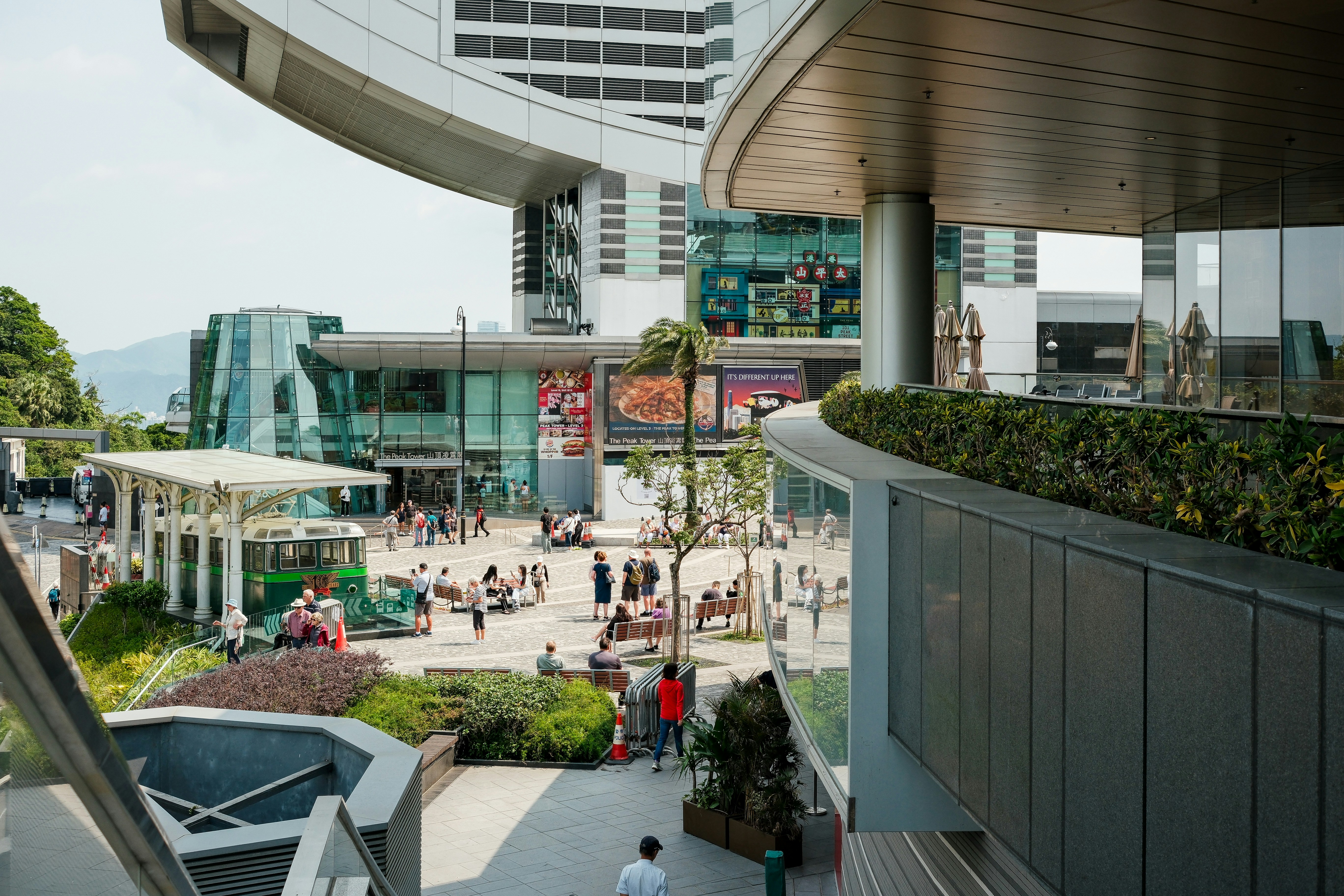 A busy outdoor plaza with shops and tourists.