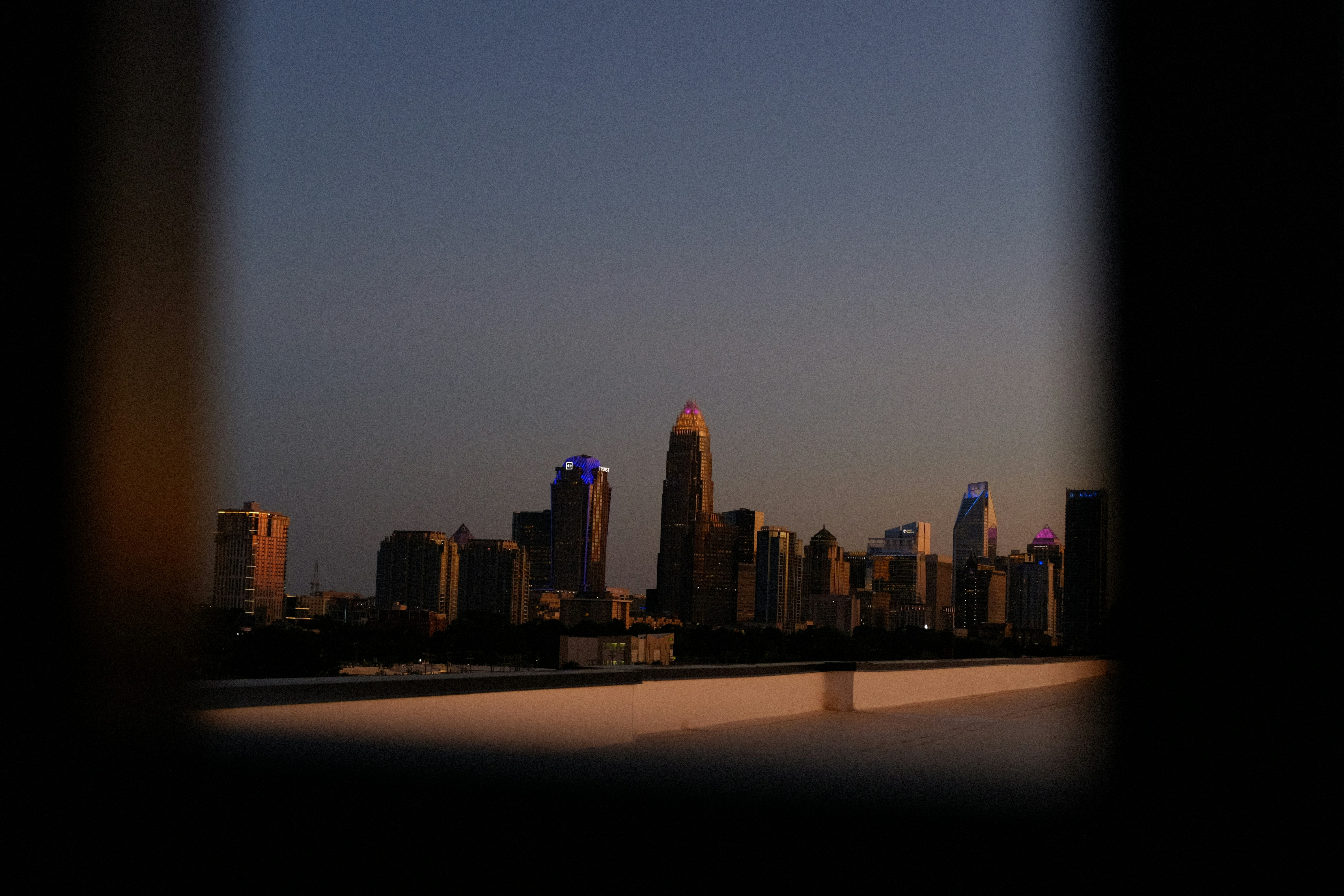A cityscape is viewed from a framed opening.