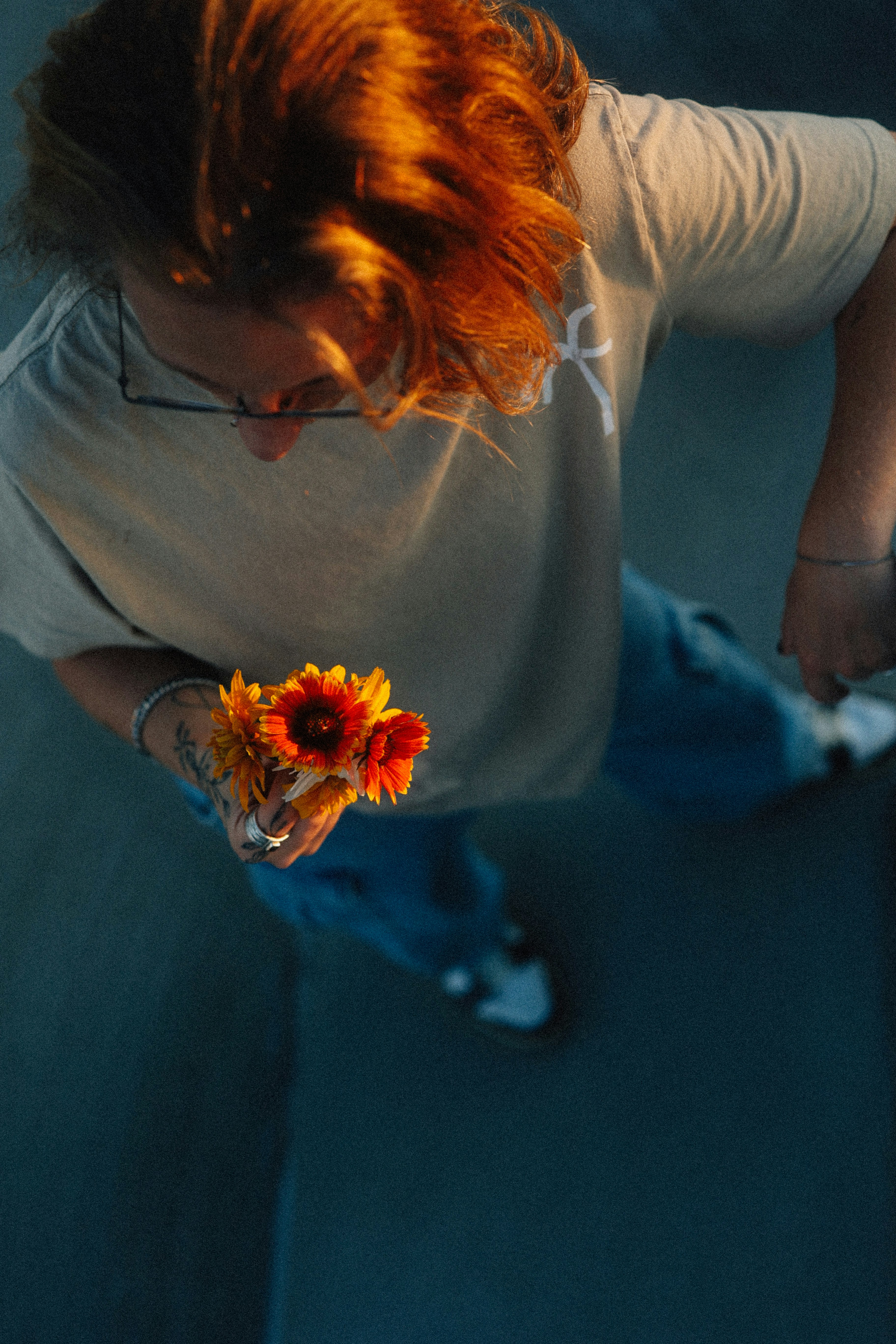 A person holds flowers from a high angle.