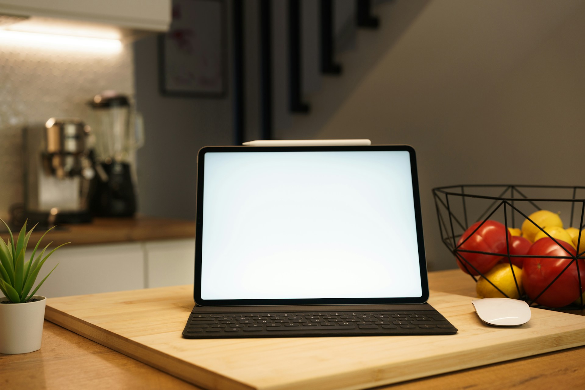 Tablet and fruit basket in a kitchen.