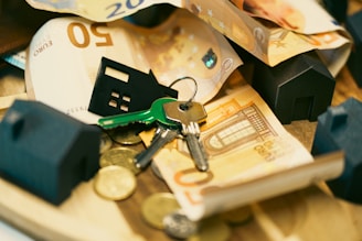 Money, keys, and miniature houses depict homeownership.