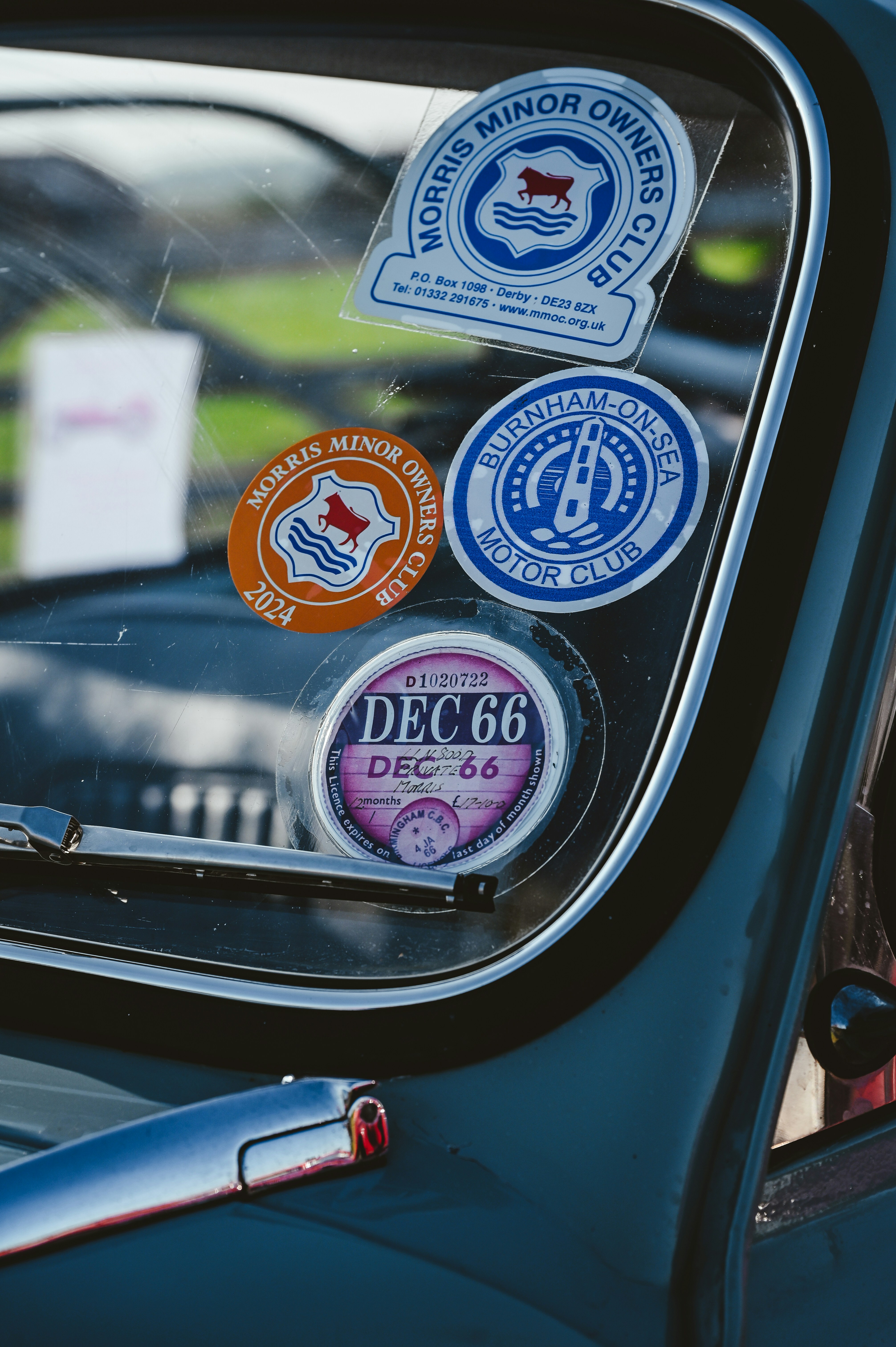 Vintage car stickers adorn the windshield.