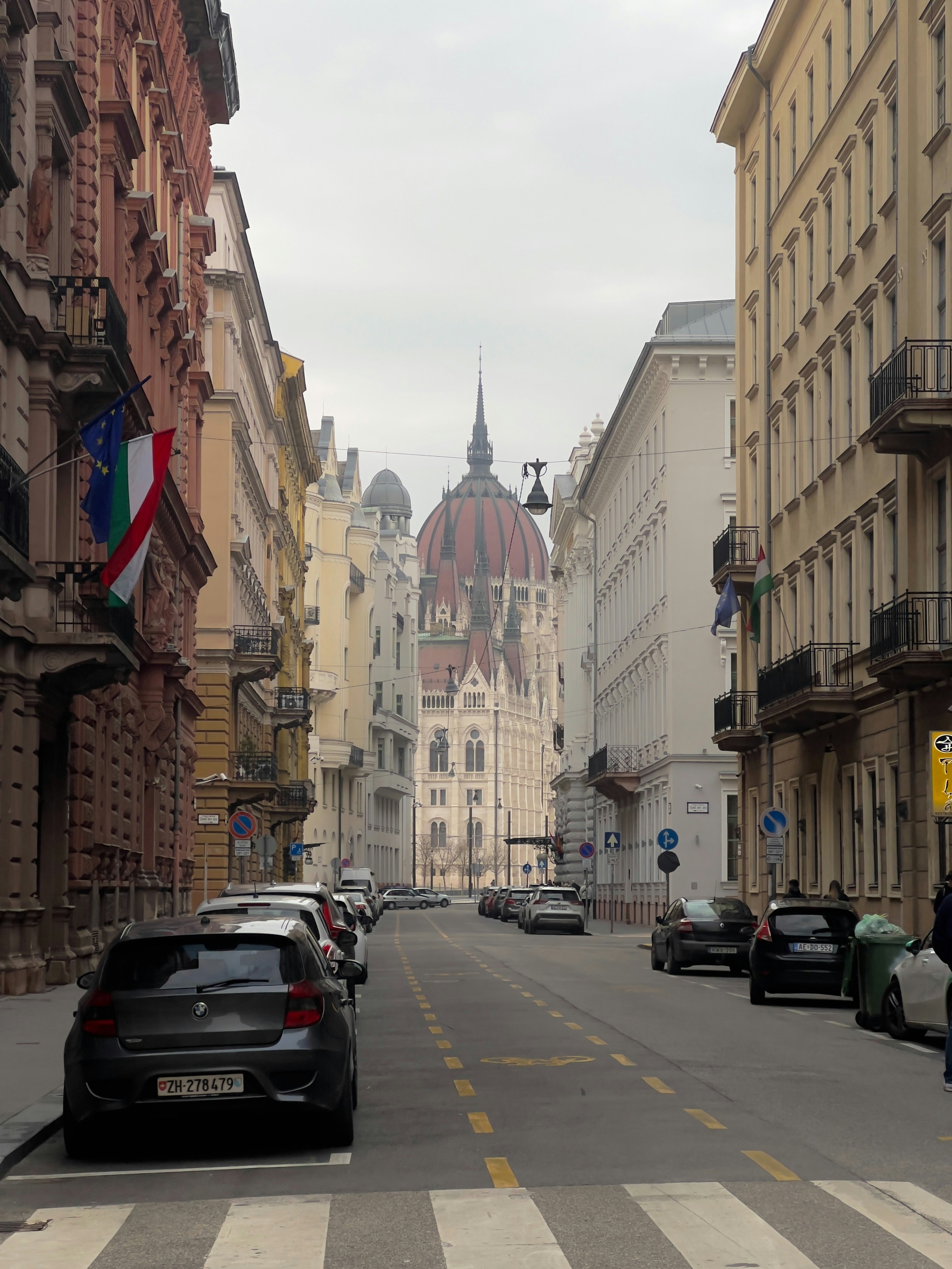 A street leads to a large, domed building.