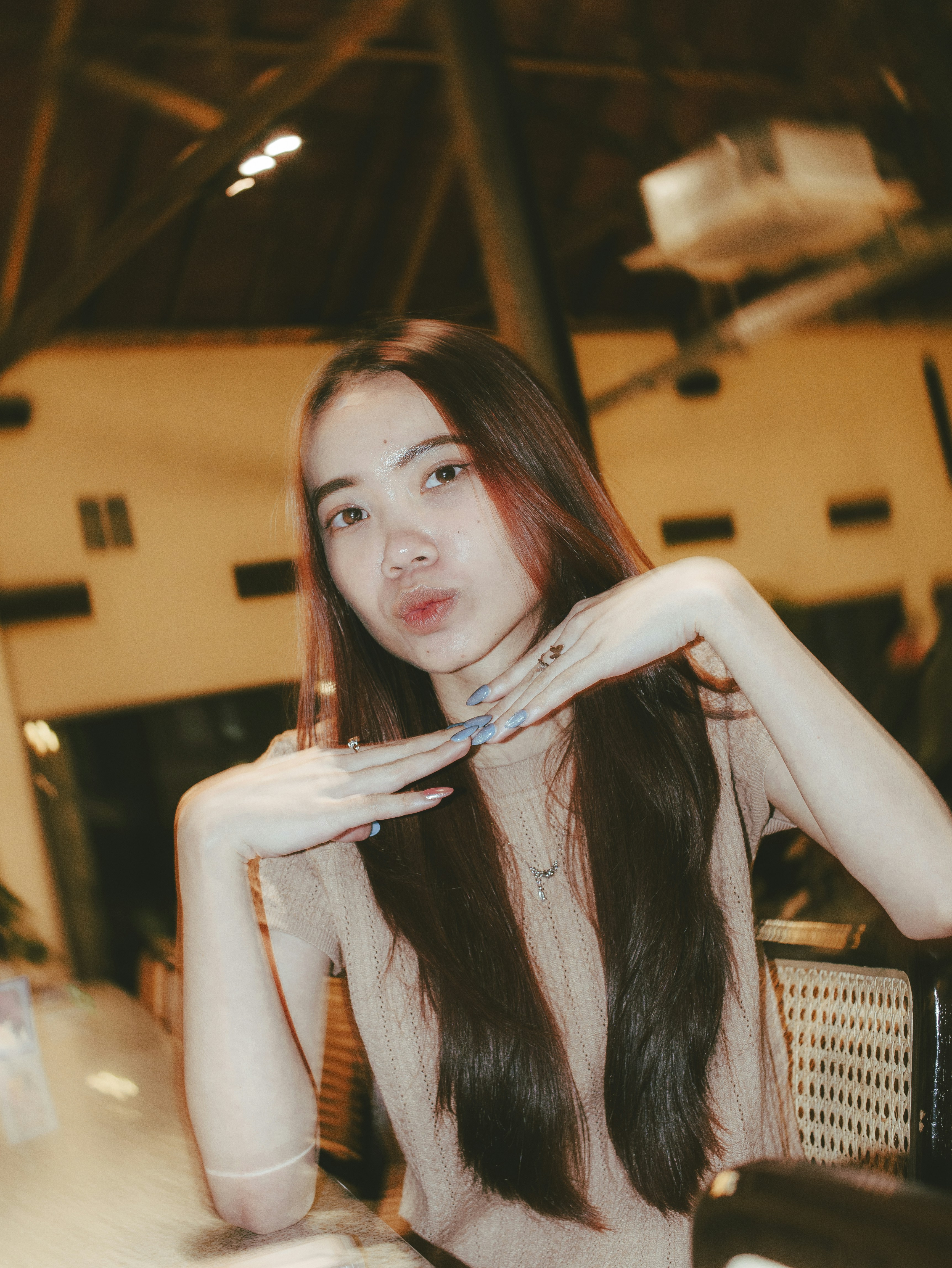 Young woman poses playfully for a picture.