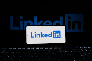 A phone displays the linkedin logo.