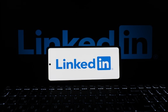A phone displays the linkedin logo.