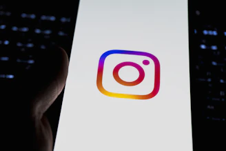 Instagram's logo is displayed on a phone.