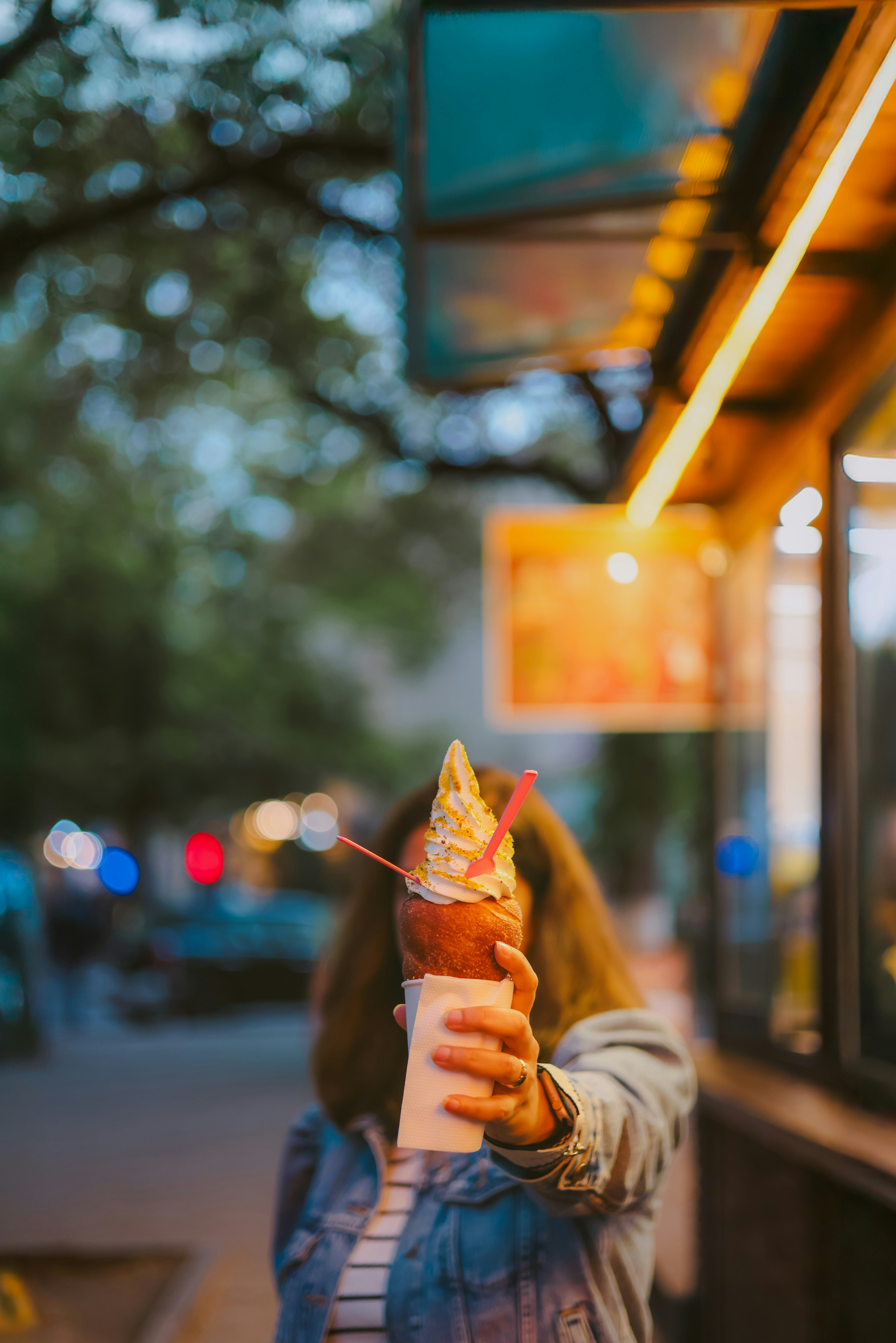A woman holds up ice cream.