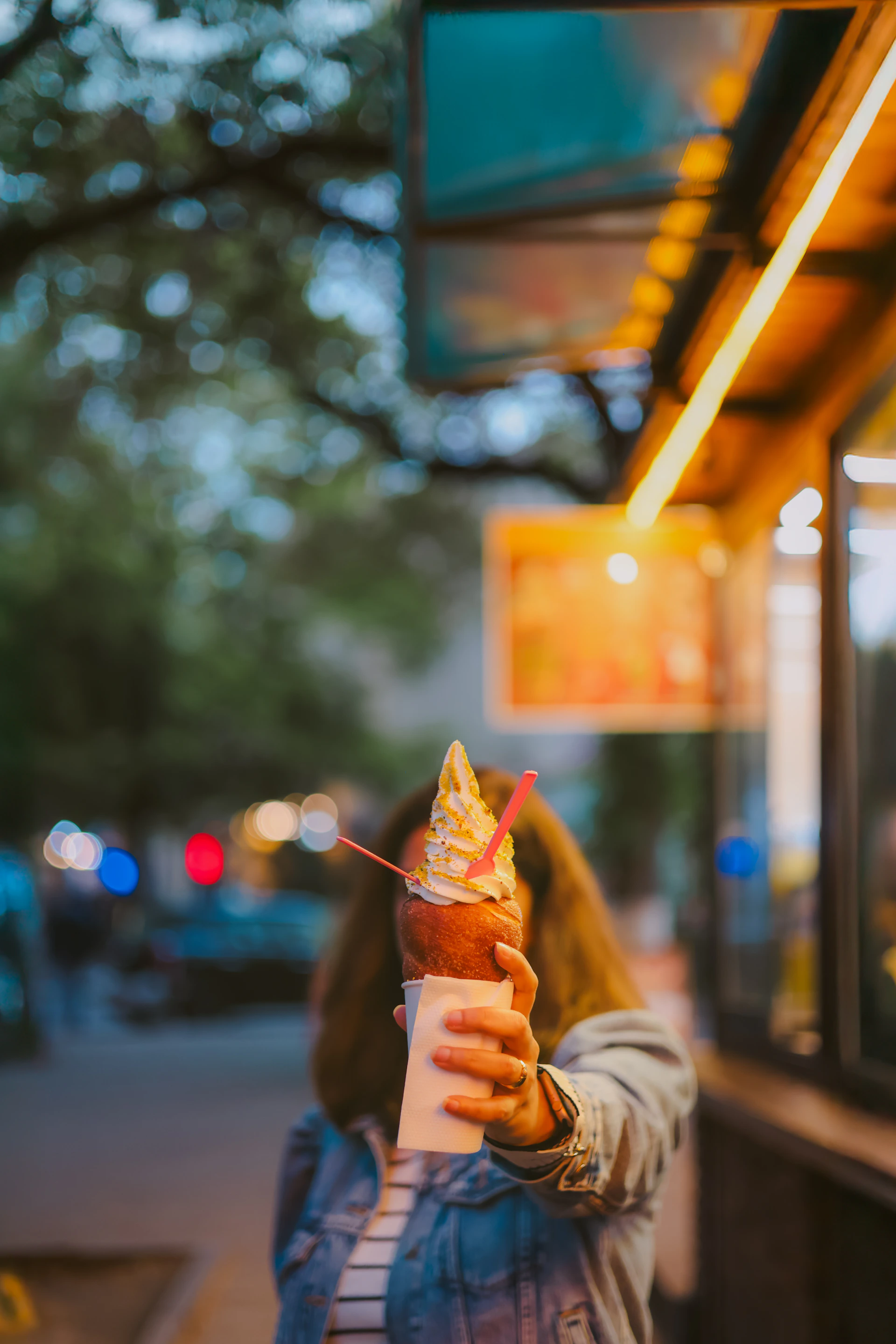 A woman holds up ice cream.