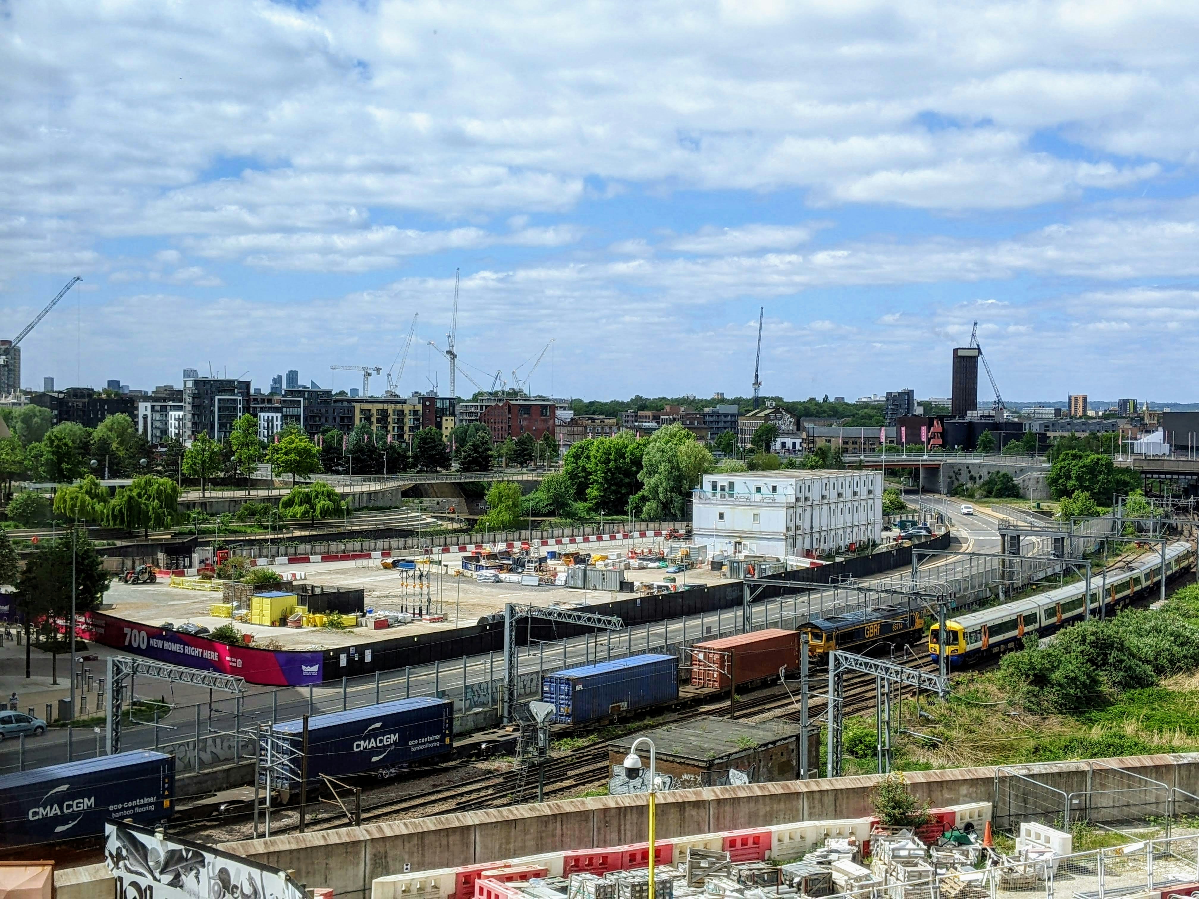 Trains travel through an urban construction zone
