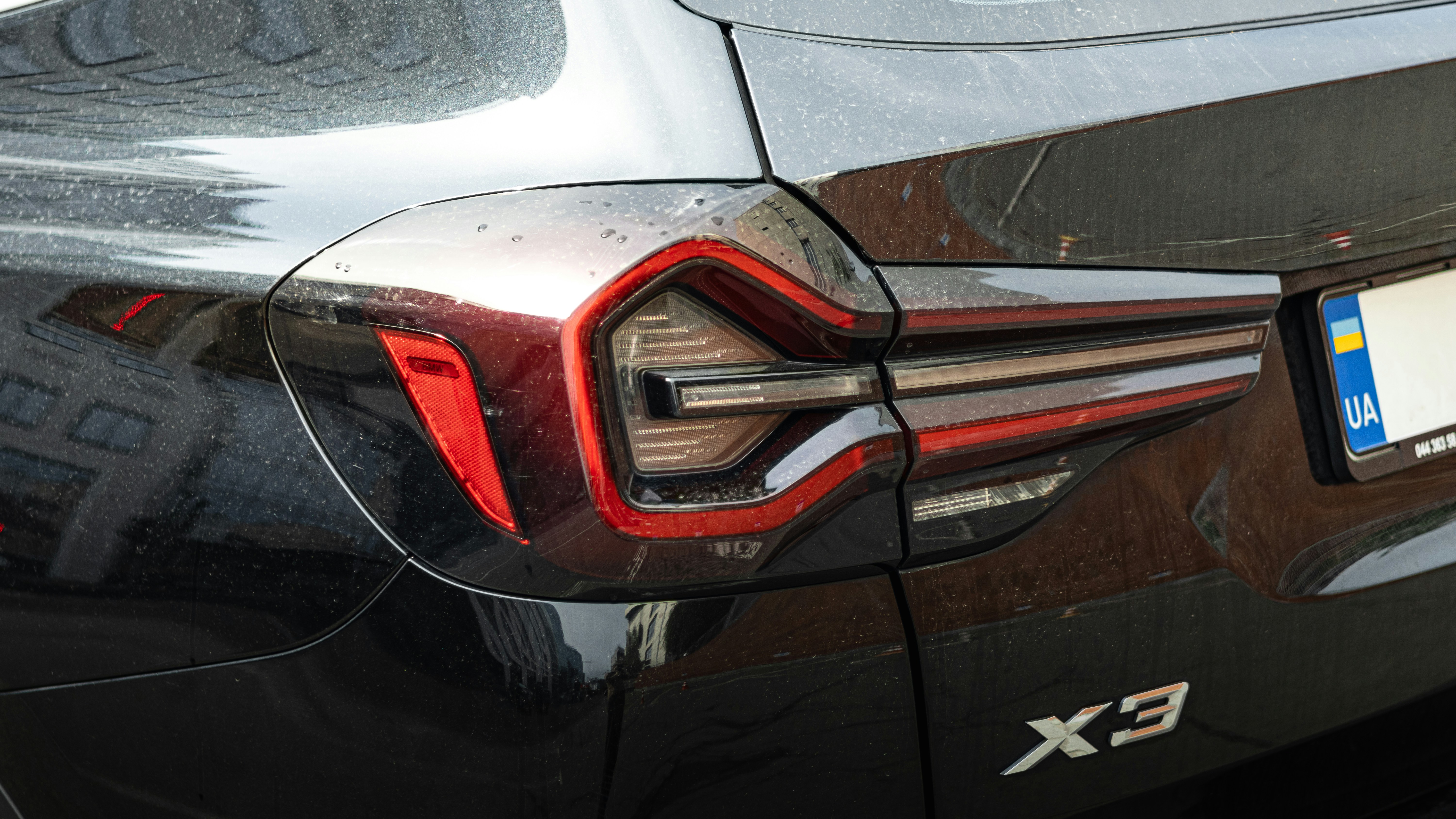 A car's taillight shows detailed lights.