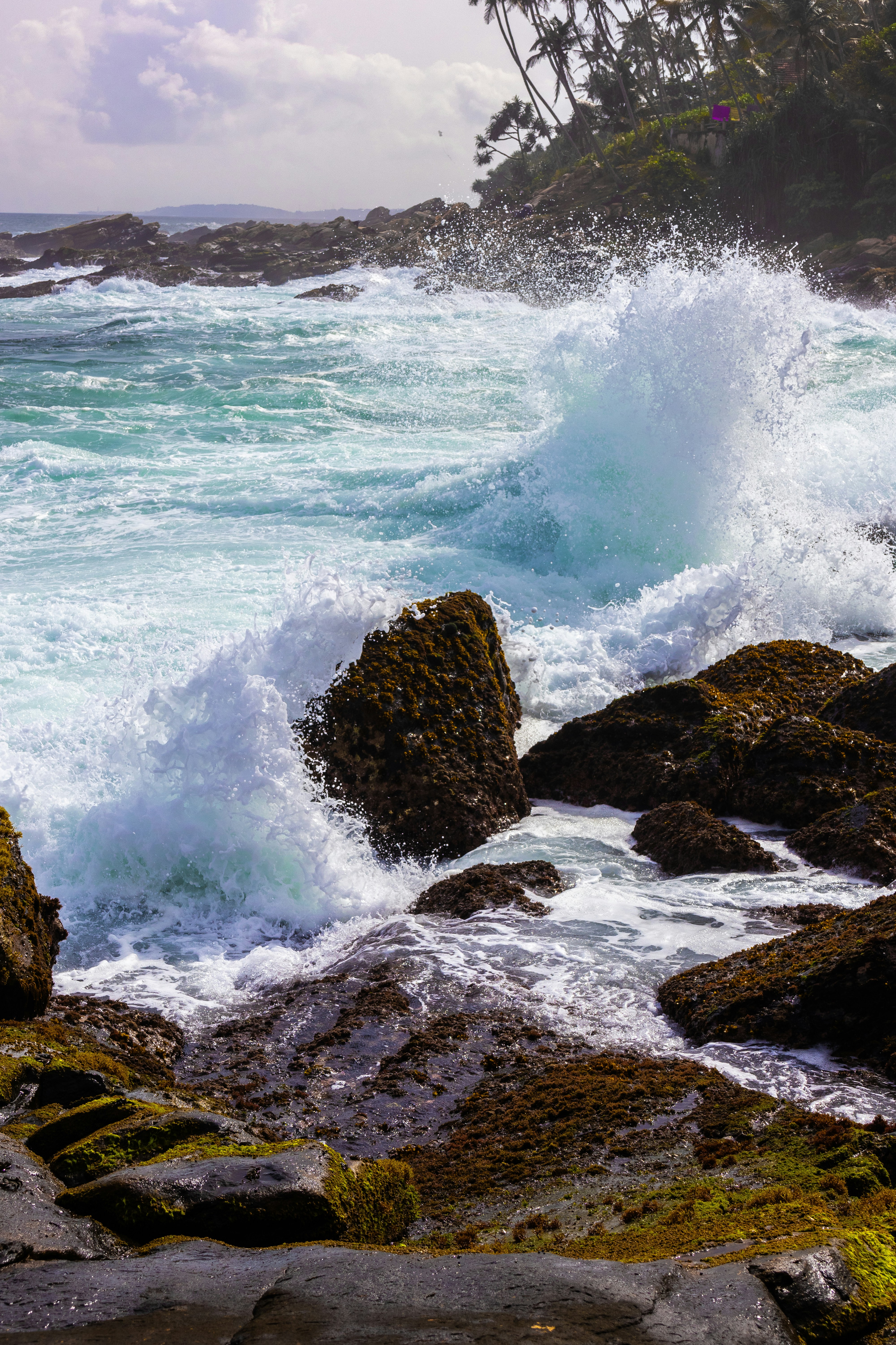 Waves crash against rocky shoreline.