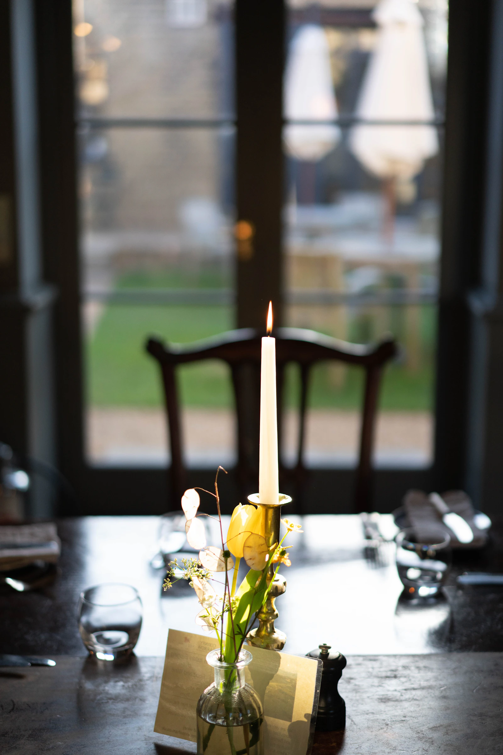 Candle and flowers on an elegant anniversary dinner table