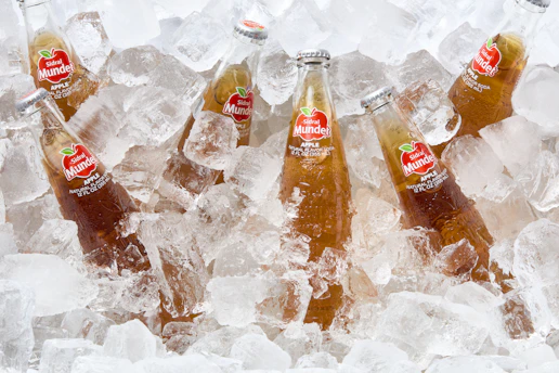 Bottled drinks sit in ice.