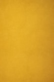A plain, textured background of golden yellow.