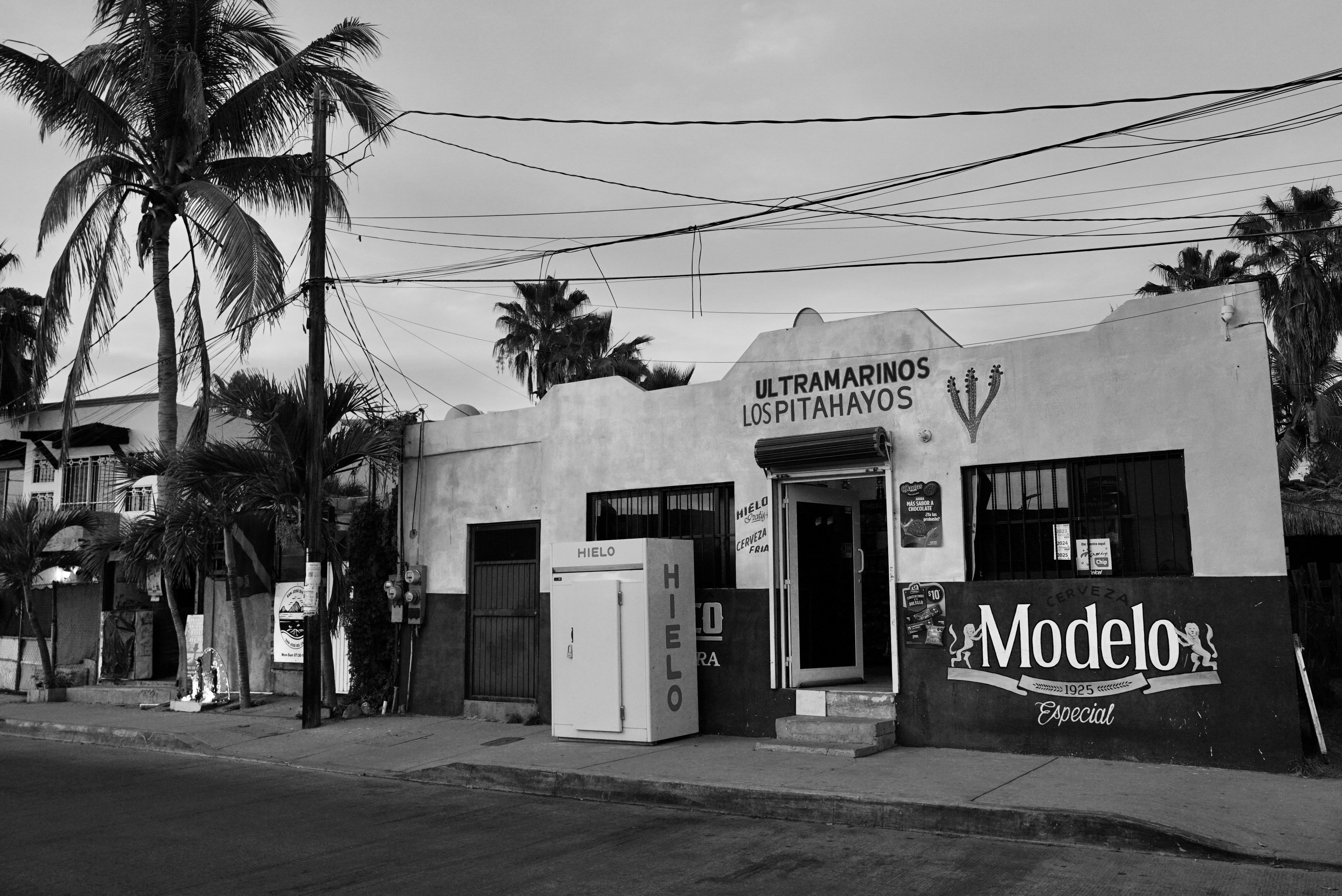 A black and white picture of a storefront.