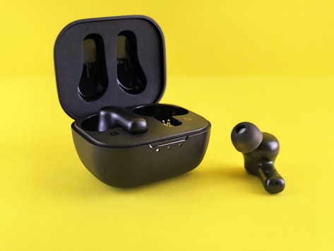 Black earbuds and their charging case.