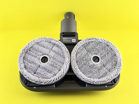 Robot vacuum cleaner head with two rotating pads.