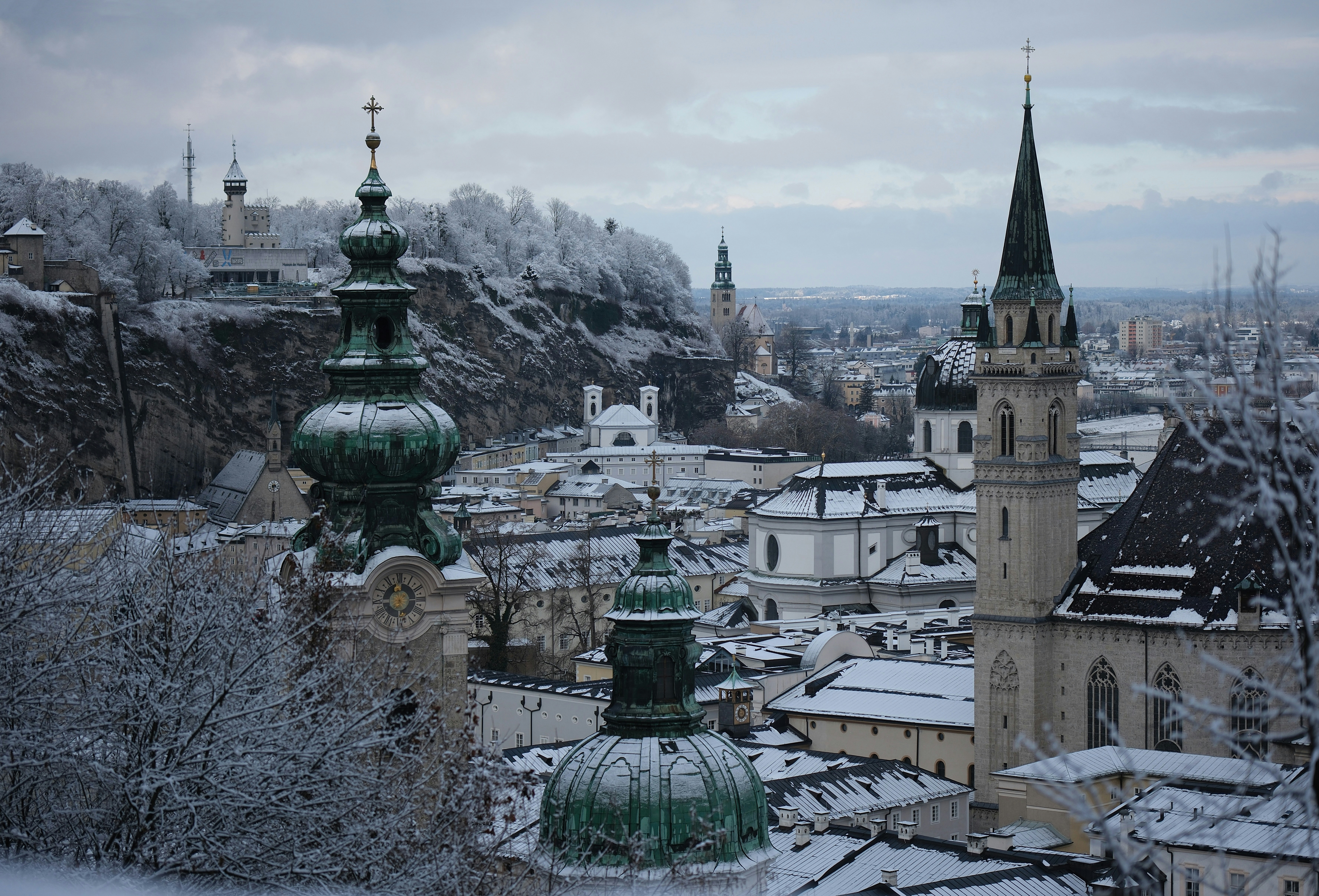 Snowy european city with church steeples.
