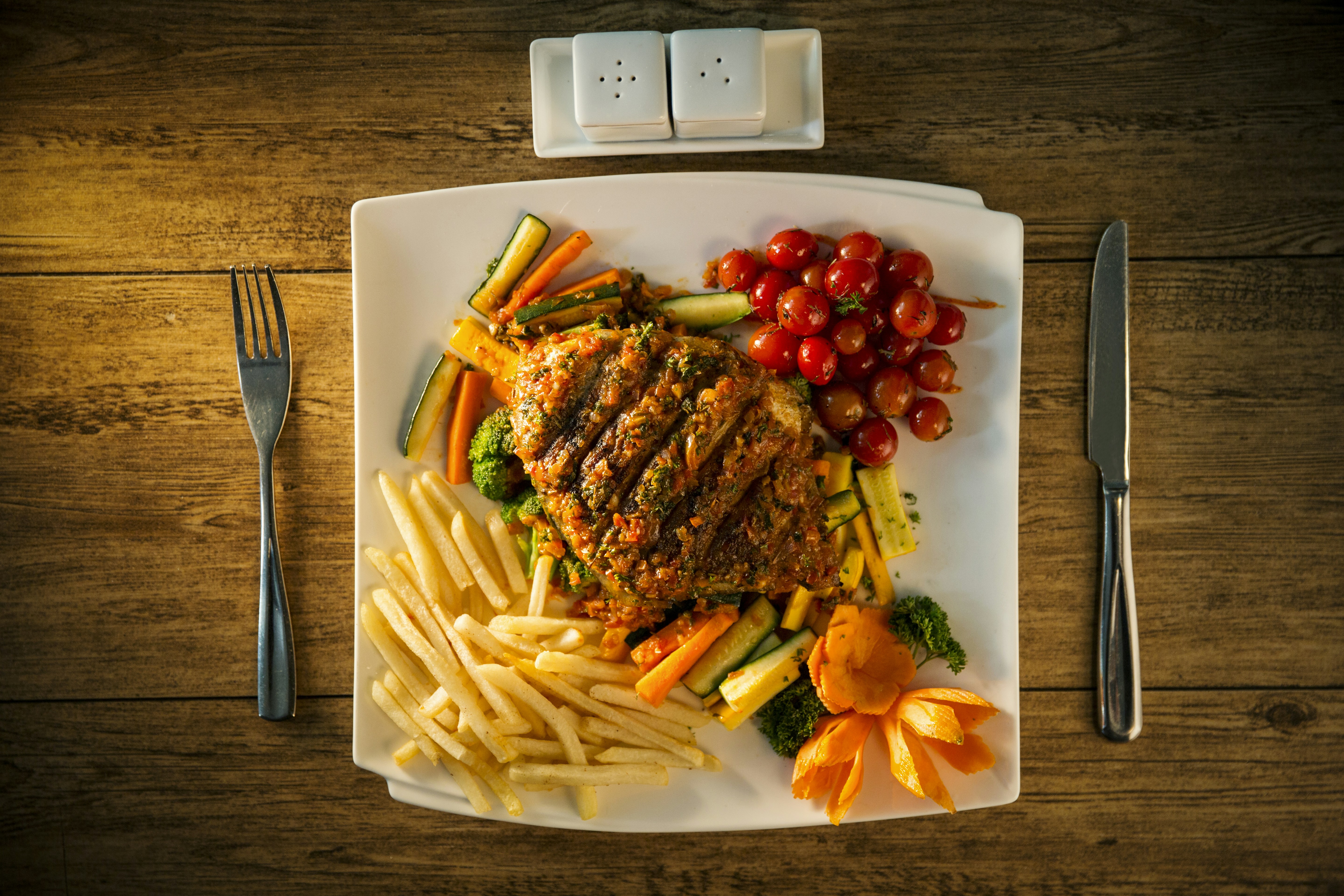 Steak, vegetables, and sides make a complete meal.
