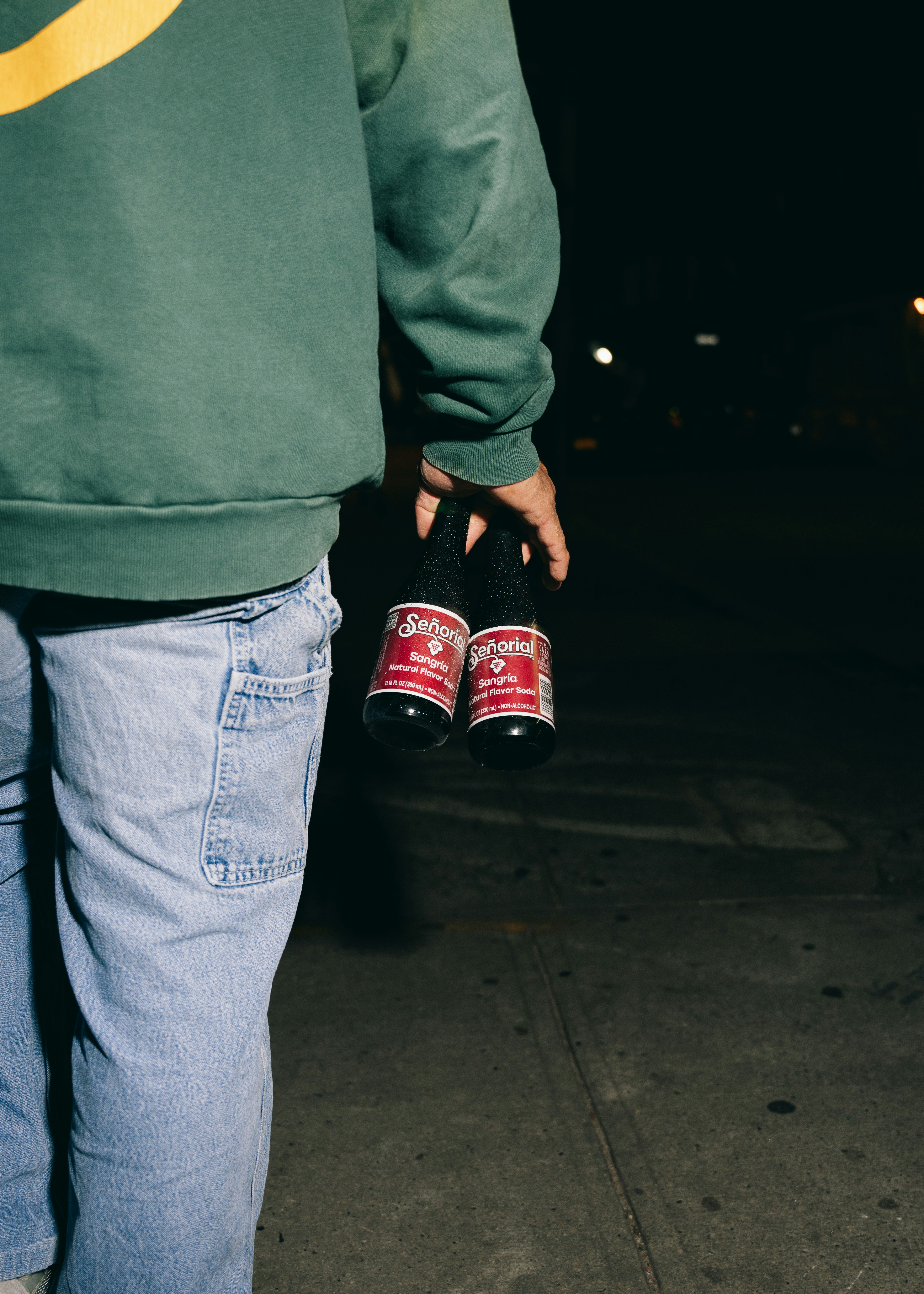 Someone is carrying two bottles of beer.