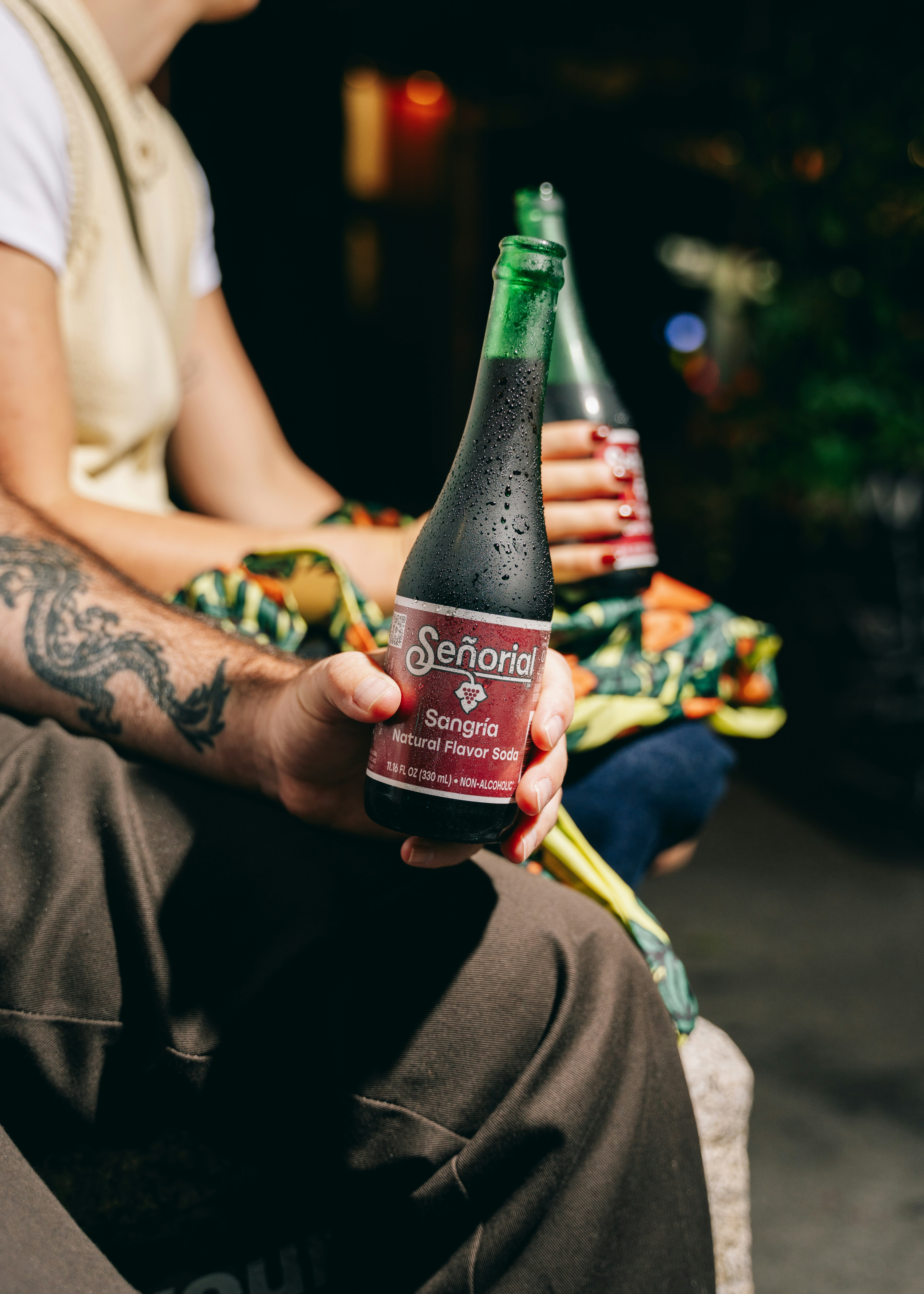 People hold bottles of señorío sangria.