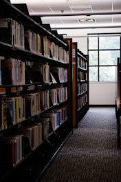 Rows of books line the shelves in the library.