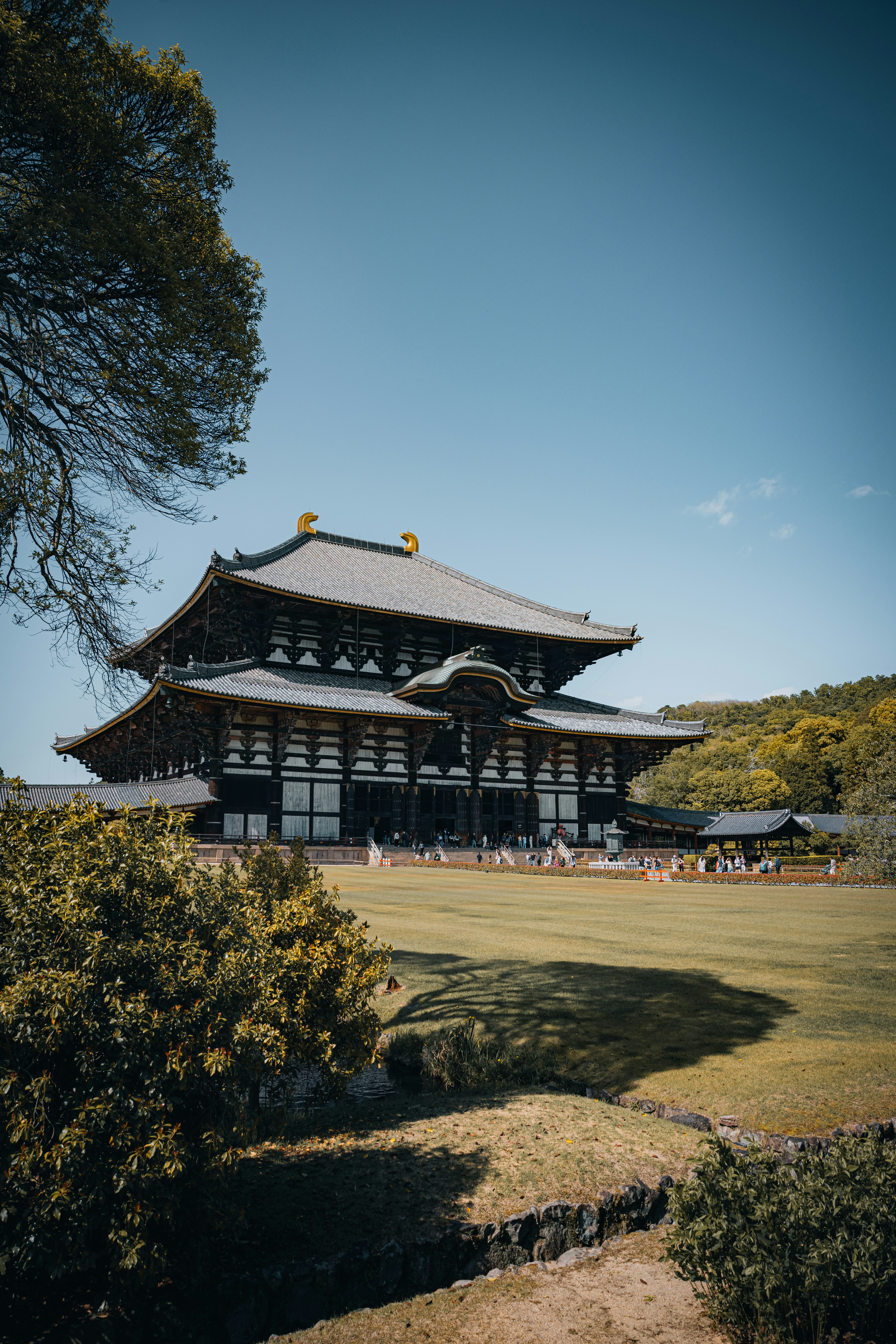 Grand temple stands tall under the bright, blue sky.
