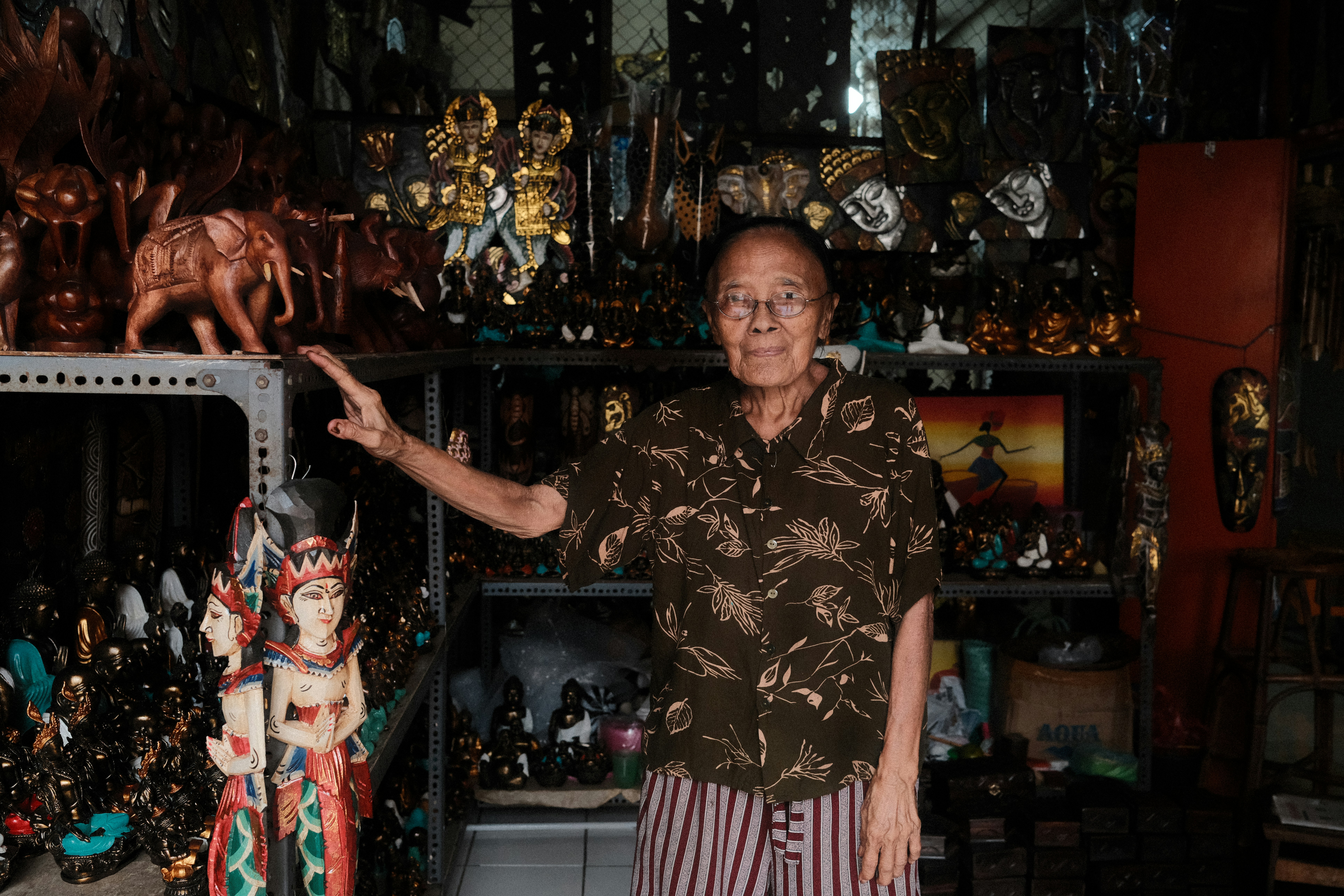 Man stands in front of his art display.