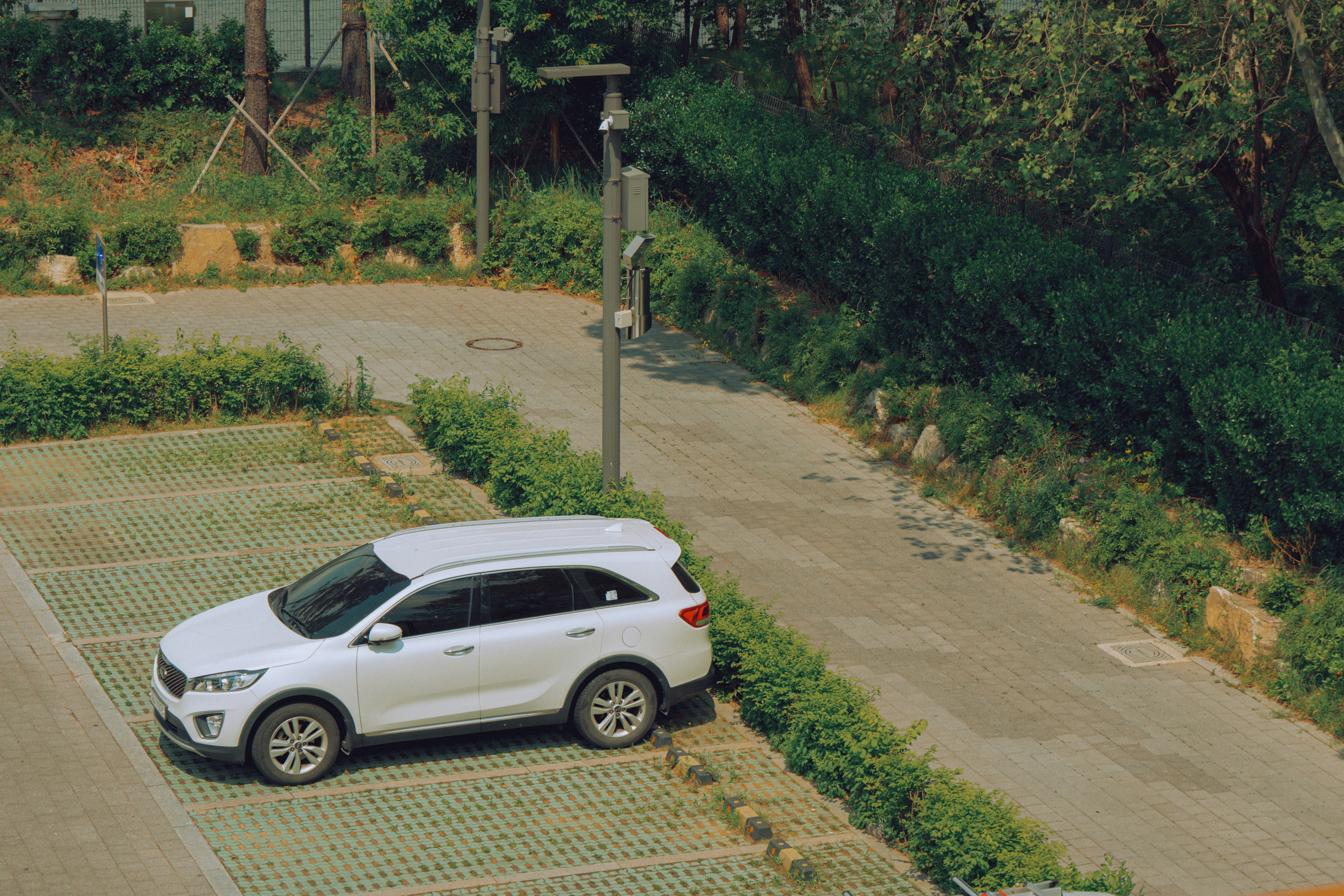 A white car is parked in an empty lot.