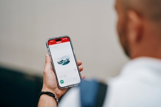A person holds a phone displaying an application.