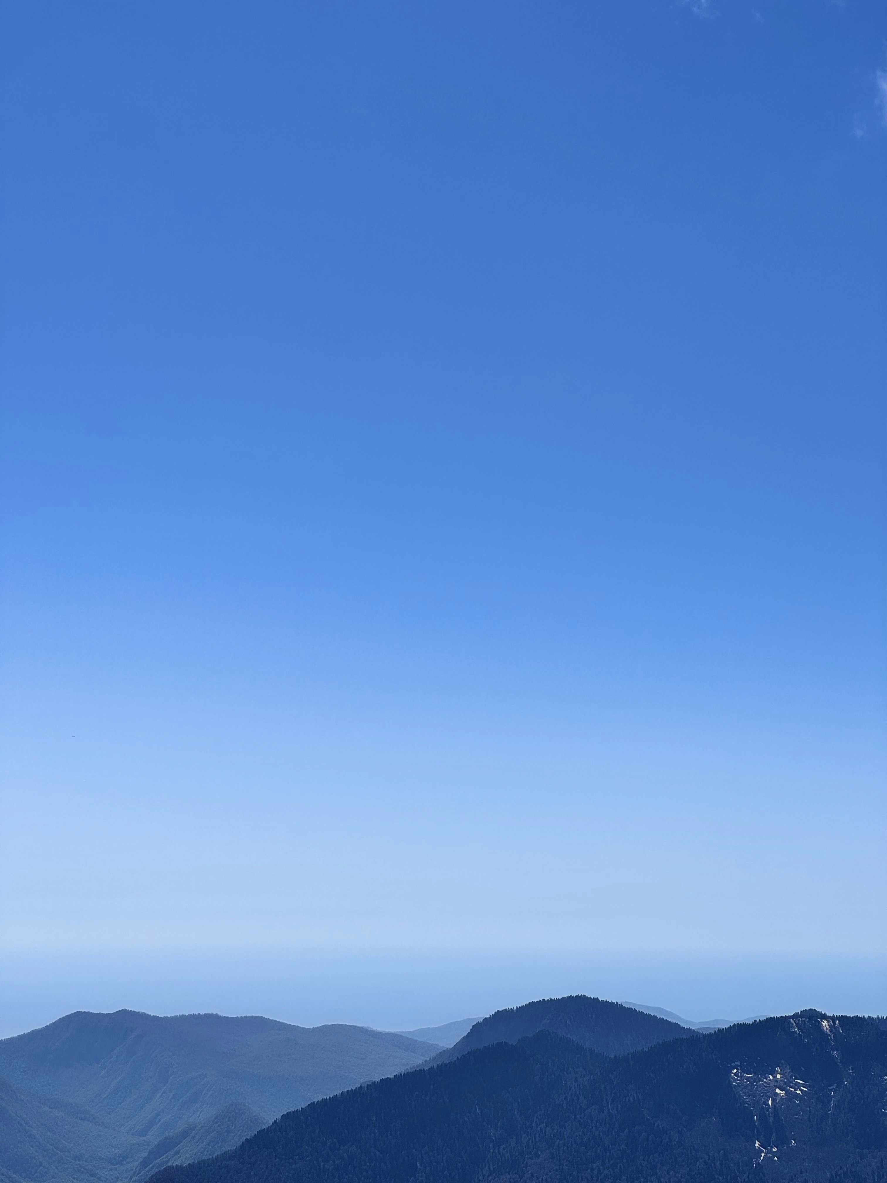 Mountains meet the vast, blue sky.