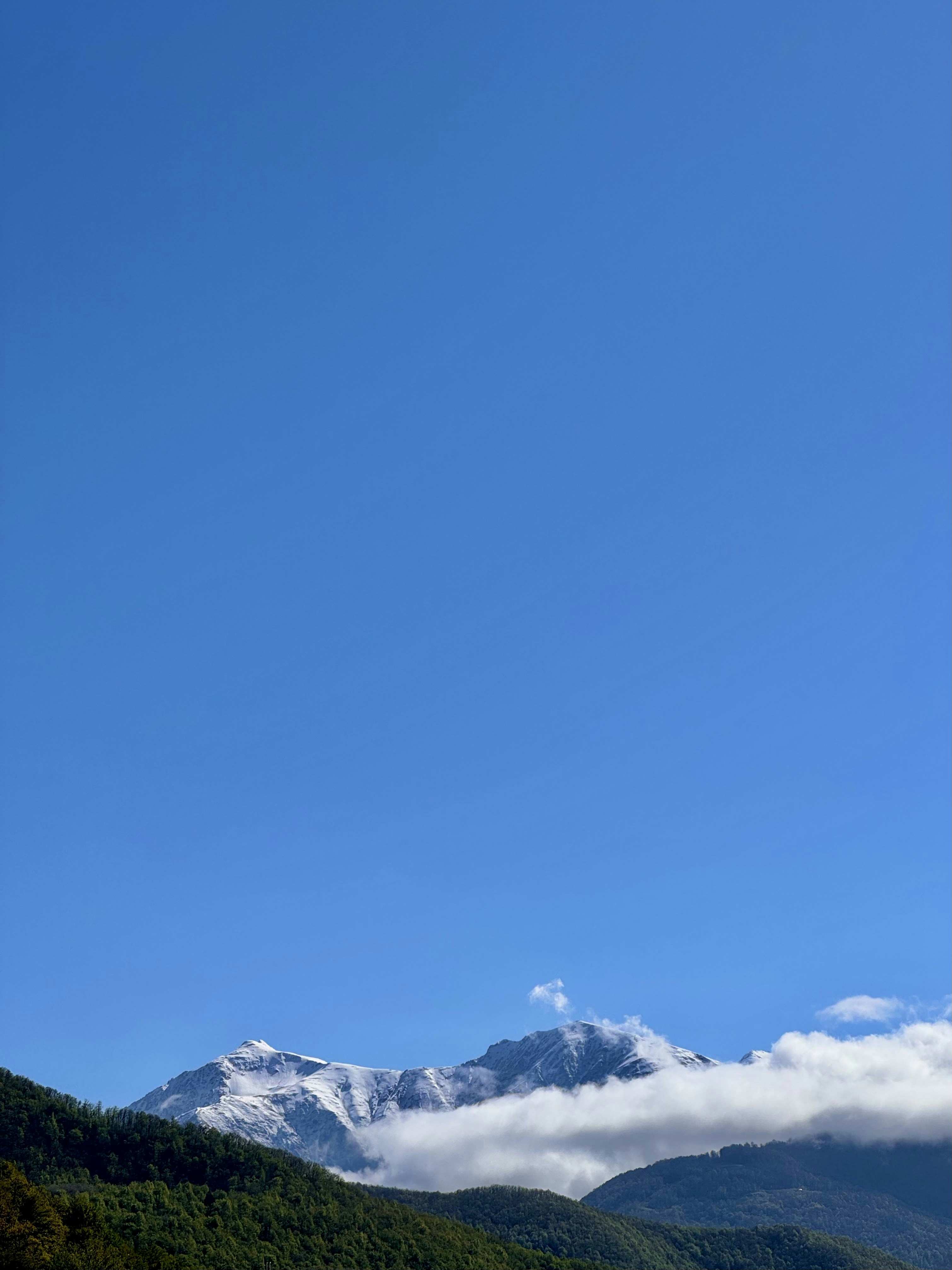 Snowy mountains and a vast blue sky.