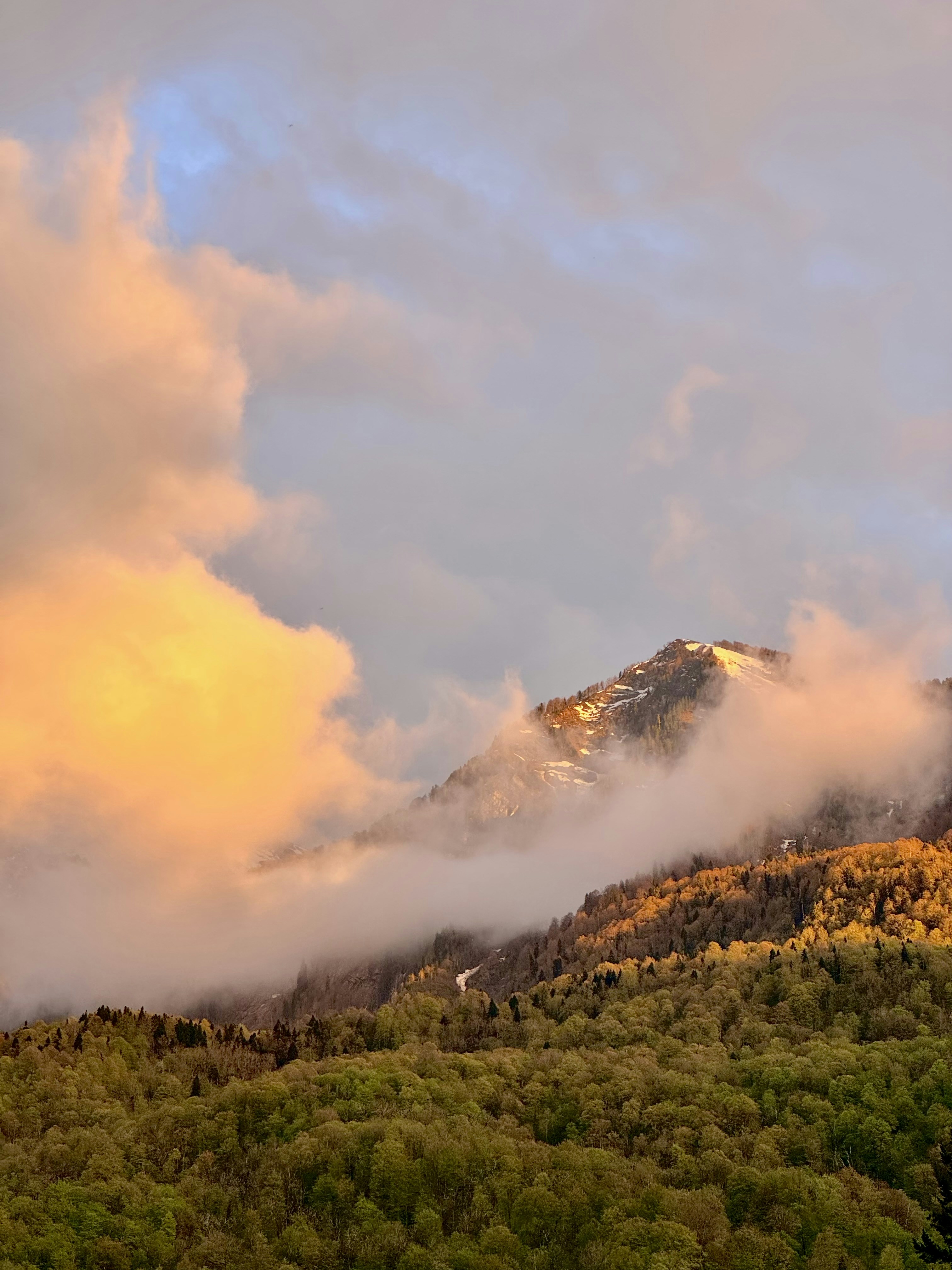 Golden sunset casts upon a mountainous landscape.