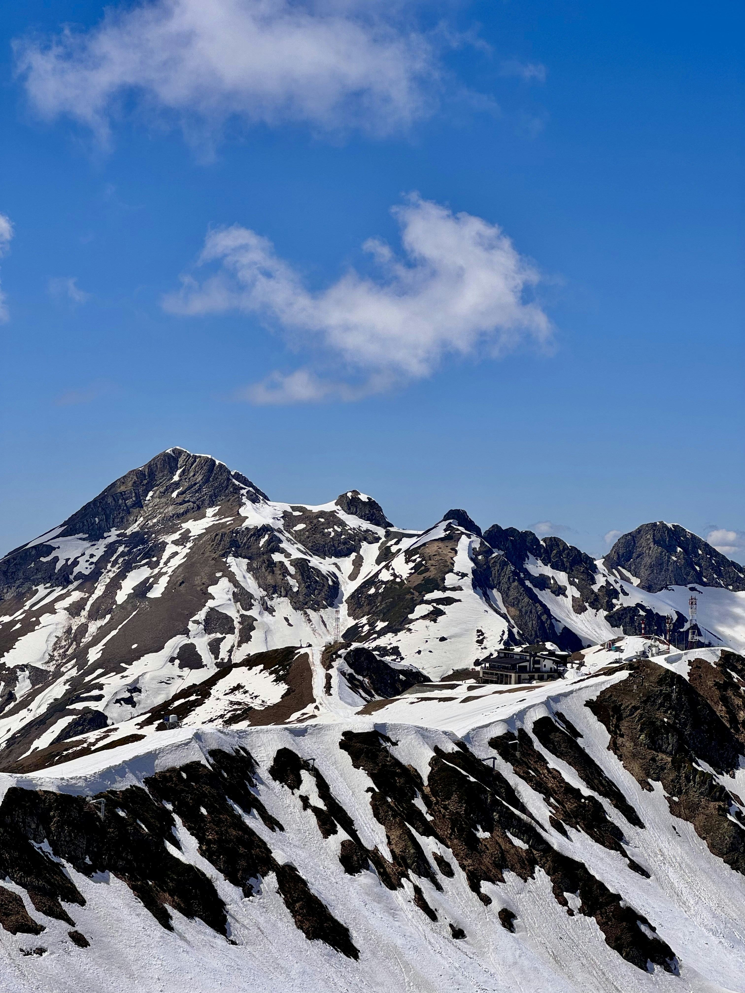 Snow-capped mountains under a bright blue sky.
