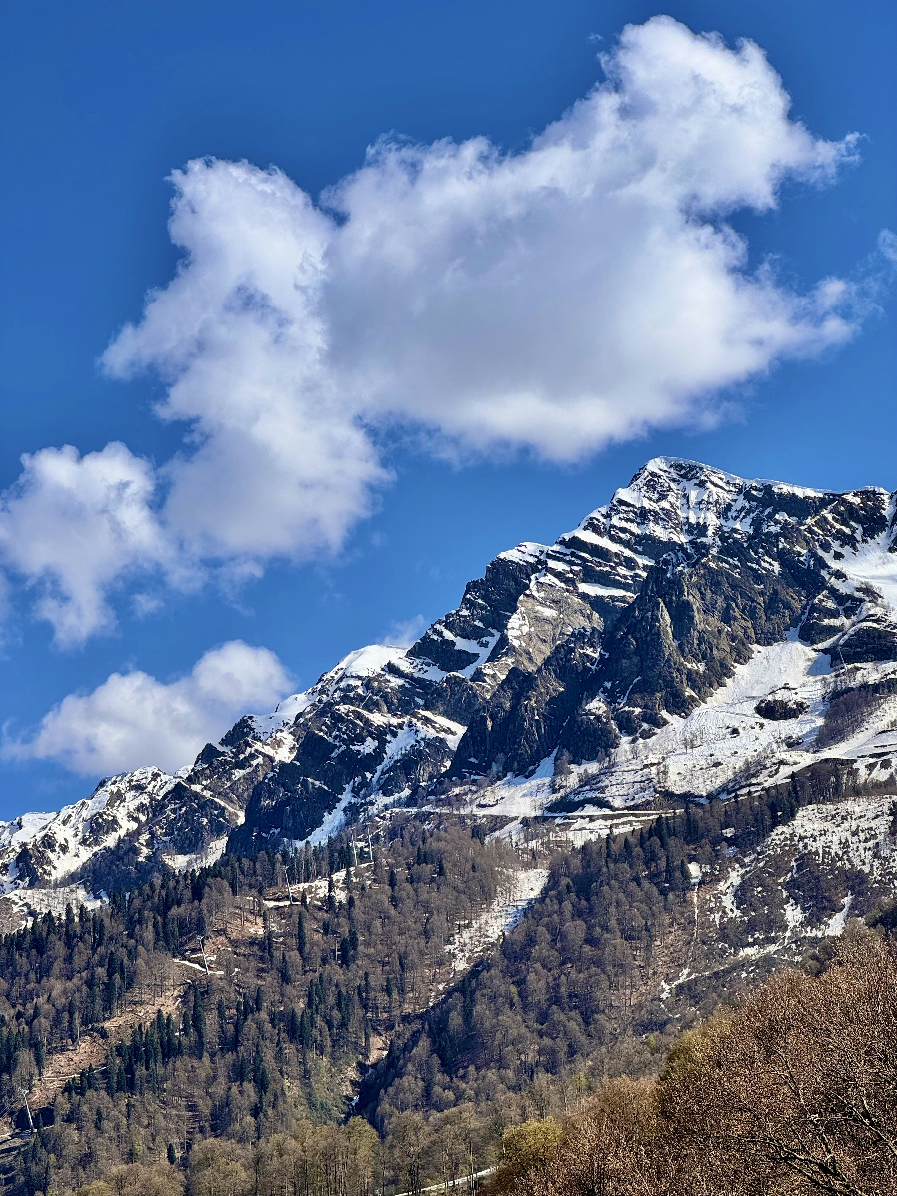 Snow-capped mountains under a blue sky.