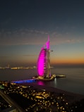 The burj al arab illuminated at twilight.