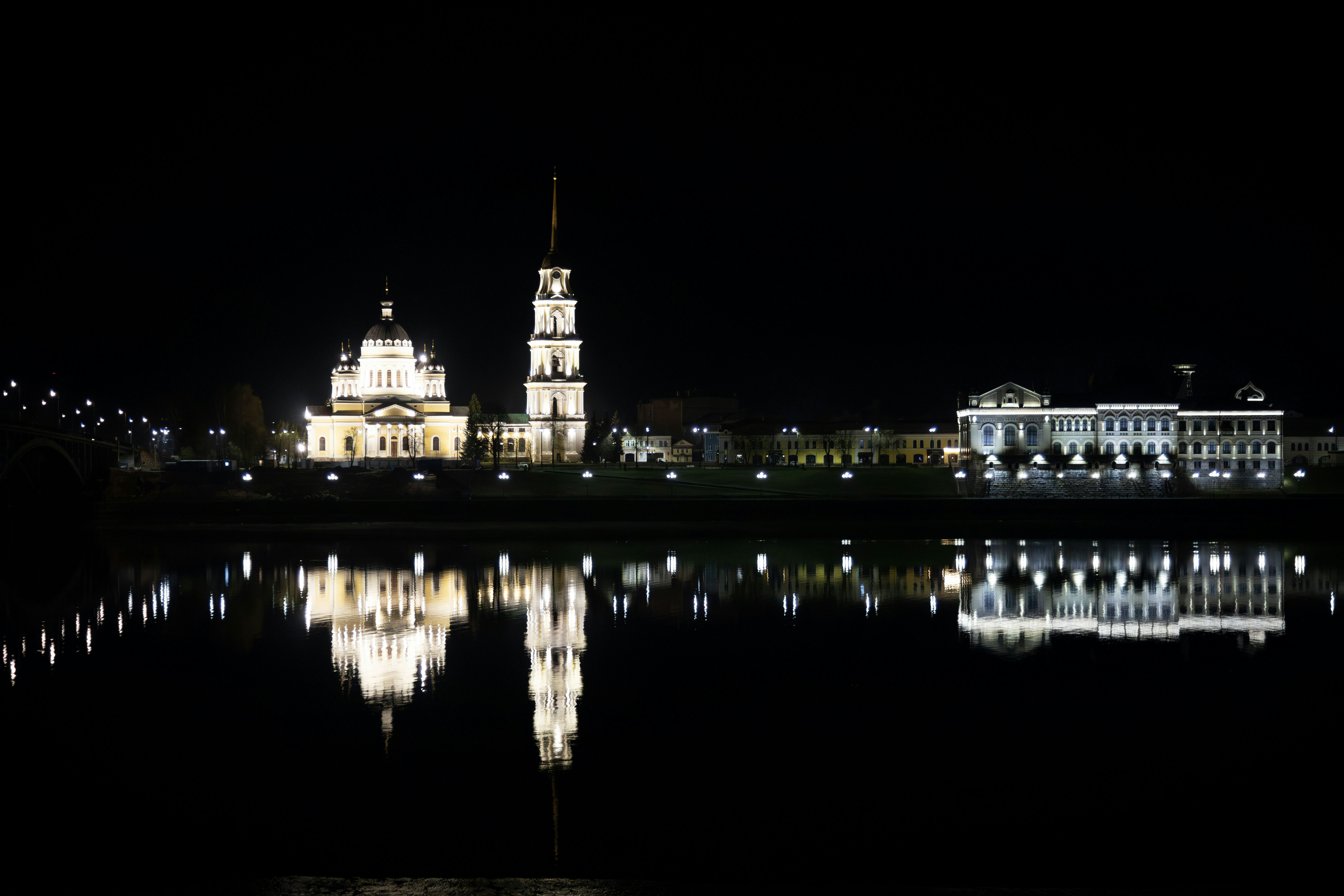 Illuminated buildings reflected in the dark water.