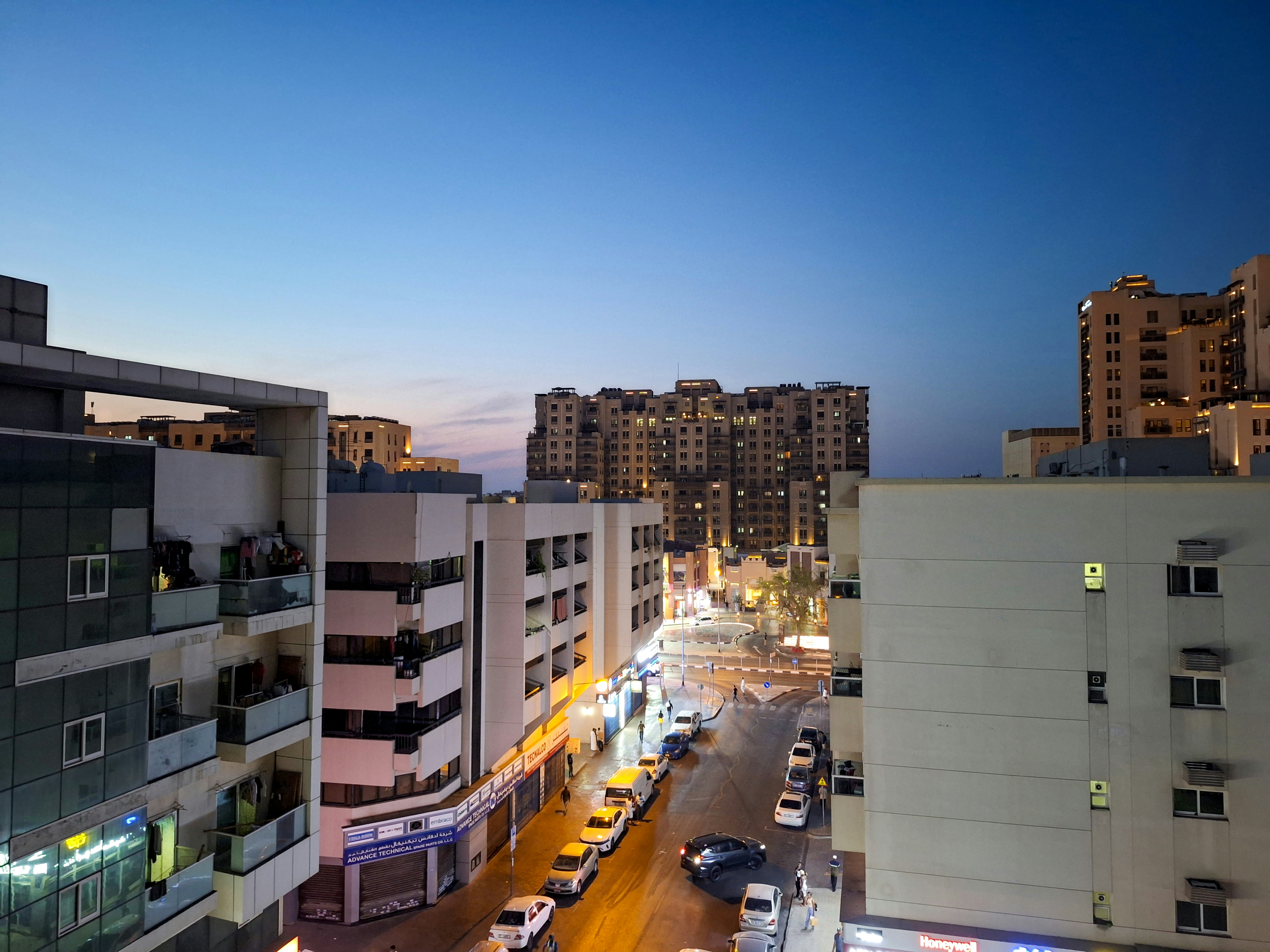 City street scene at dusk with lights.