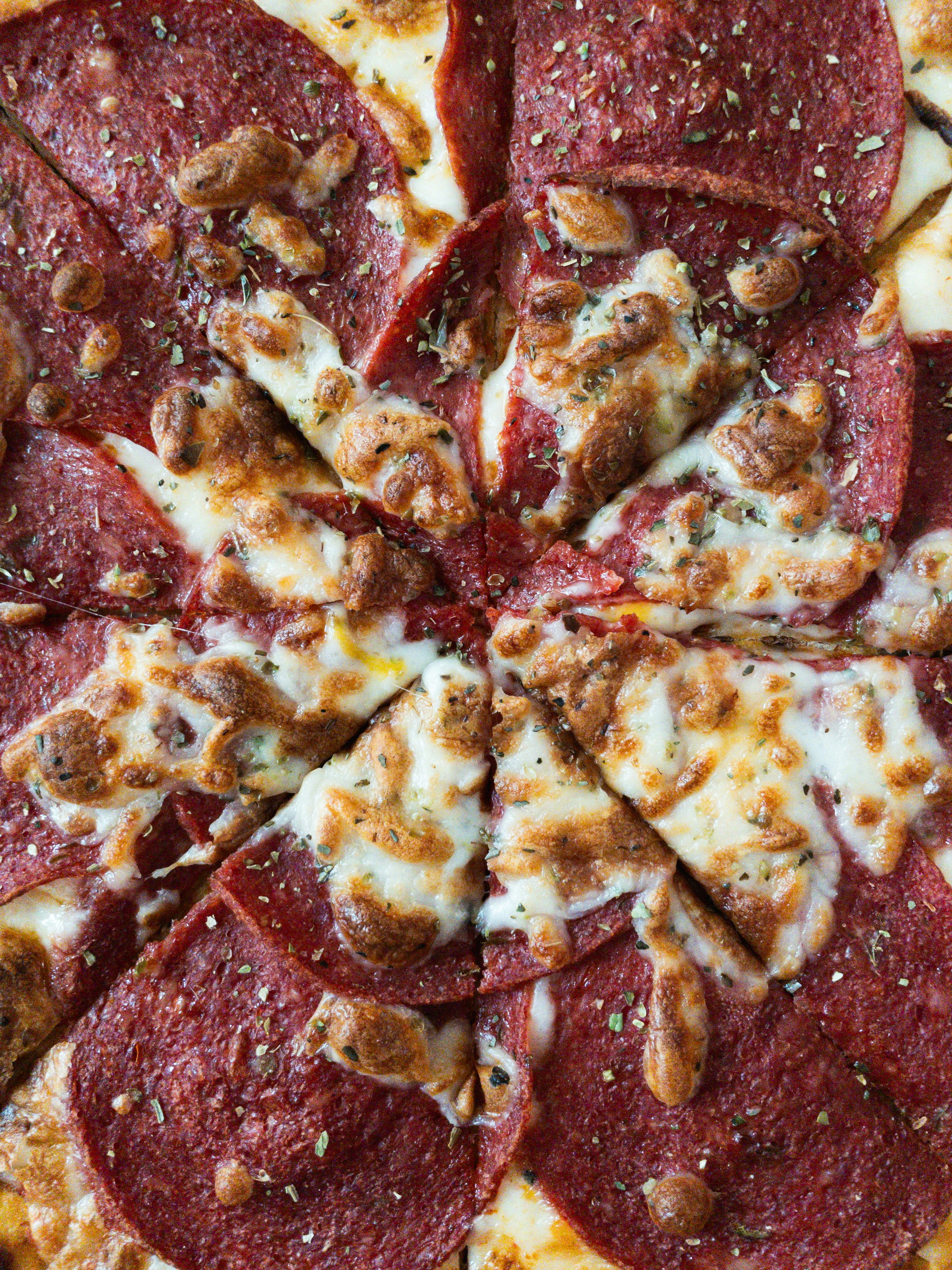A close-up shows a delicious, cheesy pepperoni pizza.