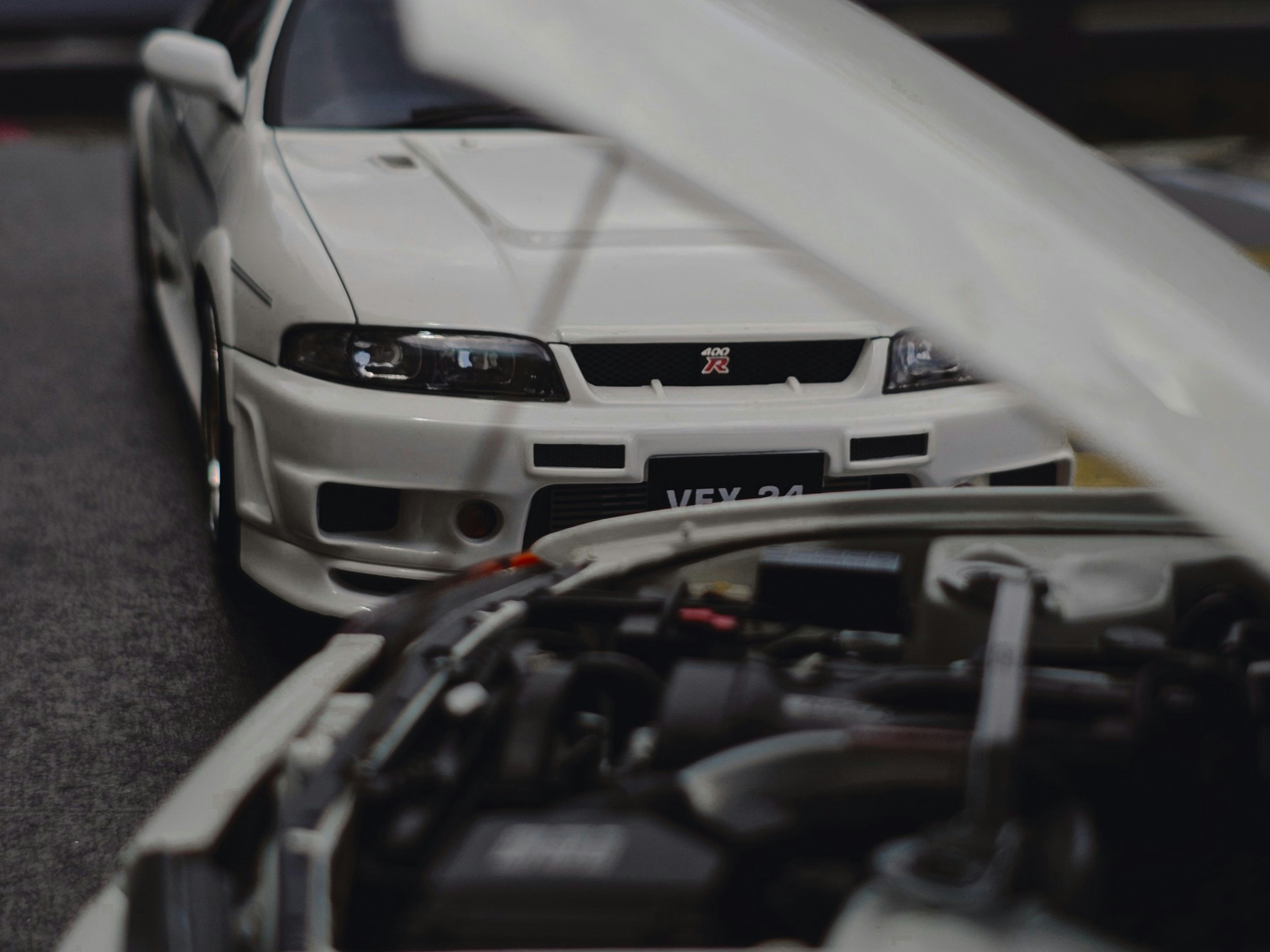Two white cars are parked close to each other.
