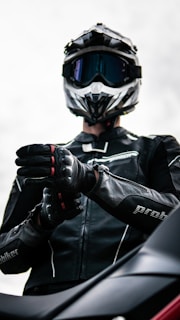 A motorcyclist is getting ready to ride.